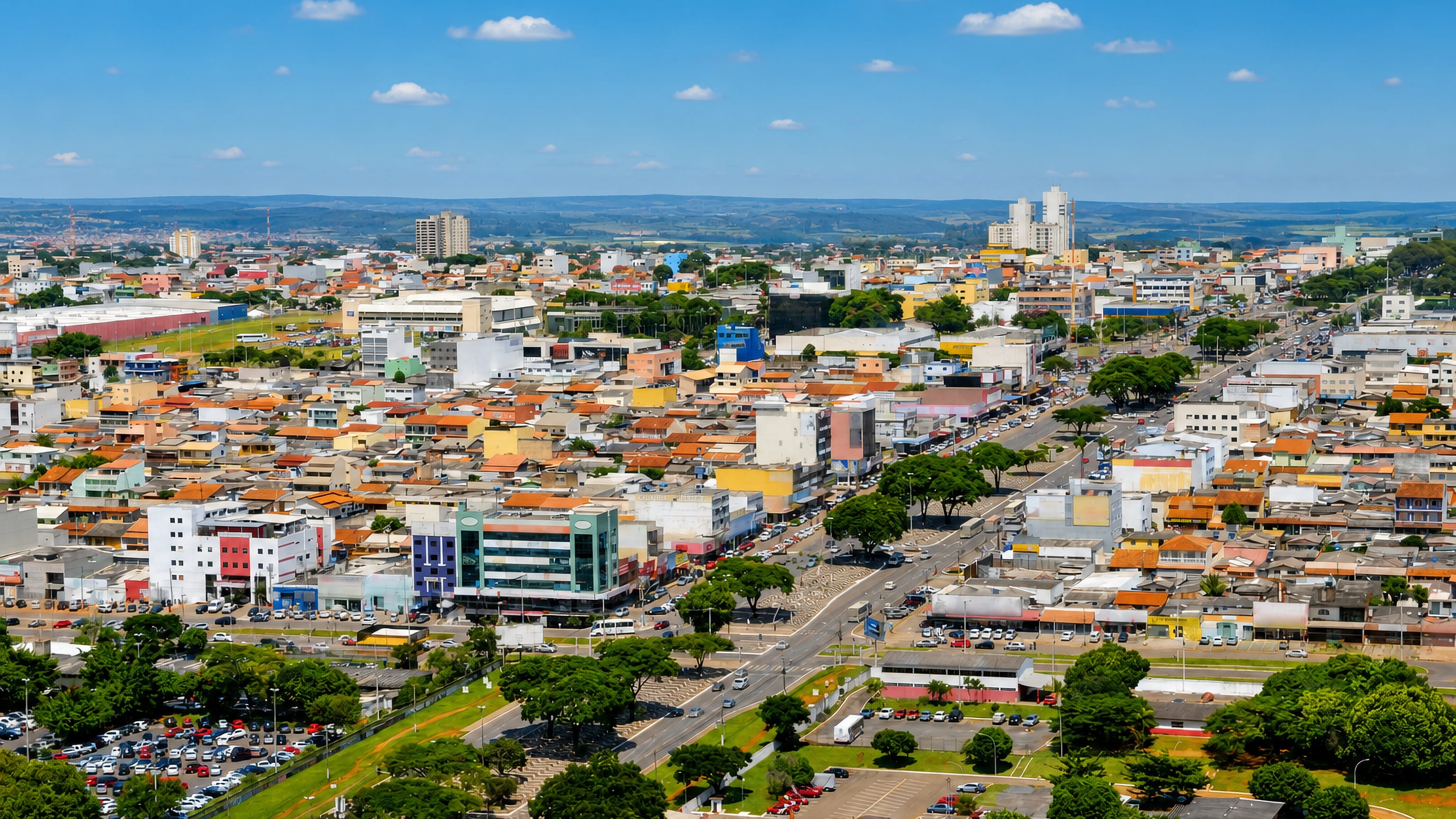 Aerial view over Ceilândia, Brazil, showing dense red-roofed housing and a busy commercial avenue.