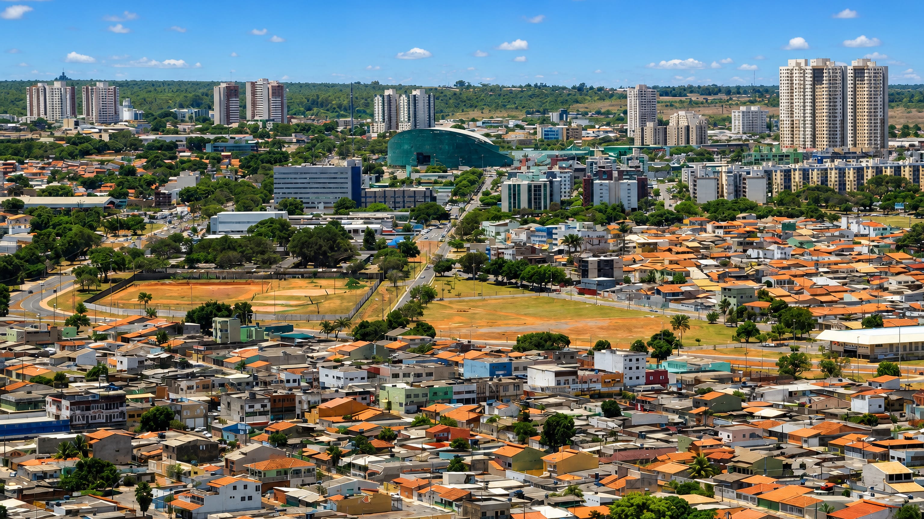 Aerial view of Gama in Brazil's Federal District: terracotta rooftops, sports fields and apartment towers.