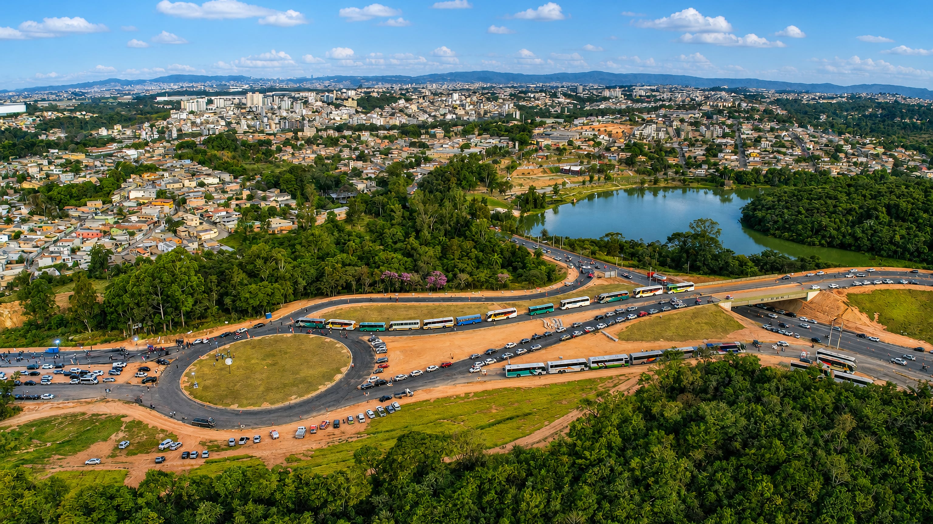 Aerial view over Contagem, Brazil, with hillside neighbourhoods, a wooded lake and a busy highway interchange.