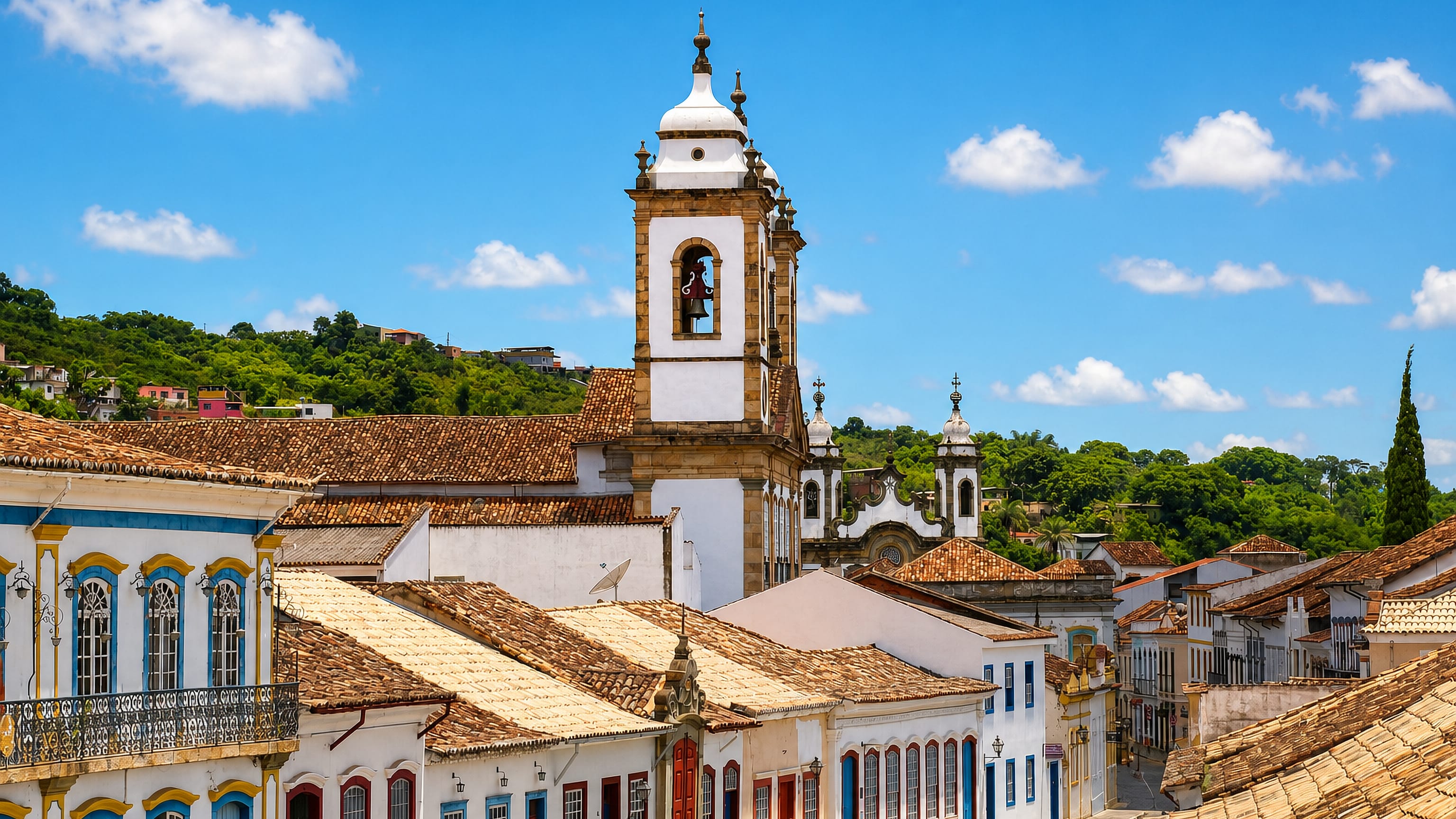 Baroque church towers rising above colonial tiled rooftops in São João del Rei, Minas Gerais.