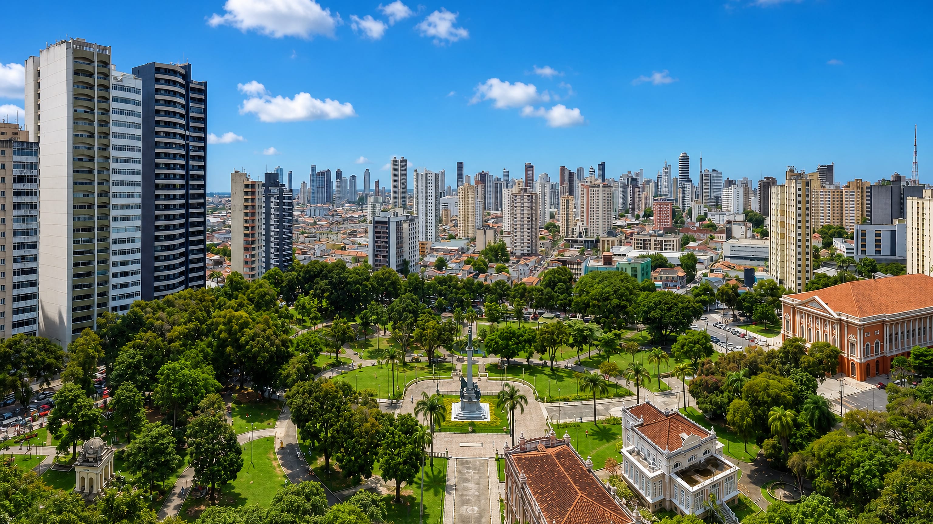 Belem's tower blocks rising behind a tree-filled central square and neoclassical theatre in Para, Brazil.