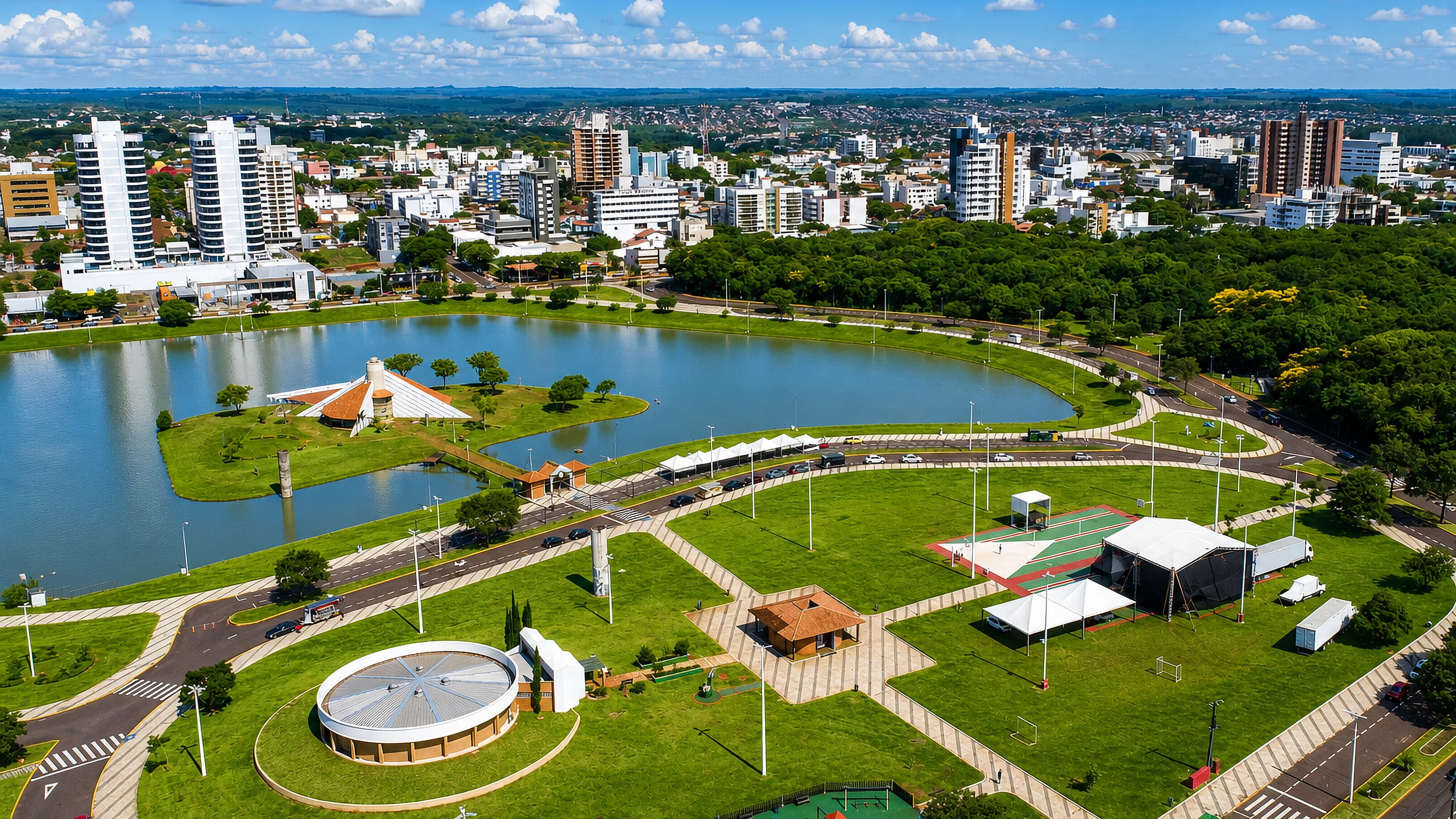 Aerial view of Toledo, Brazil, with its lakeside municipal park, paved promenades and downtown towers beyond.