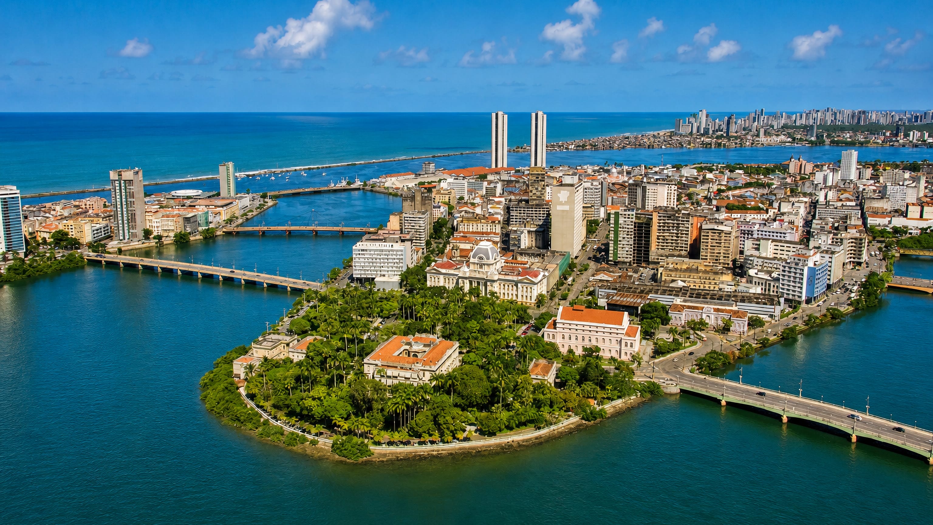 Aerial view of Recife Antigo island, the Capibaribe river bridges and the city's high-rise Atlantic waterfront.