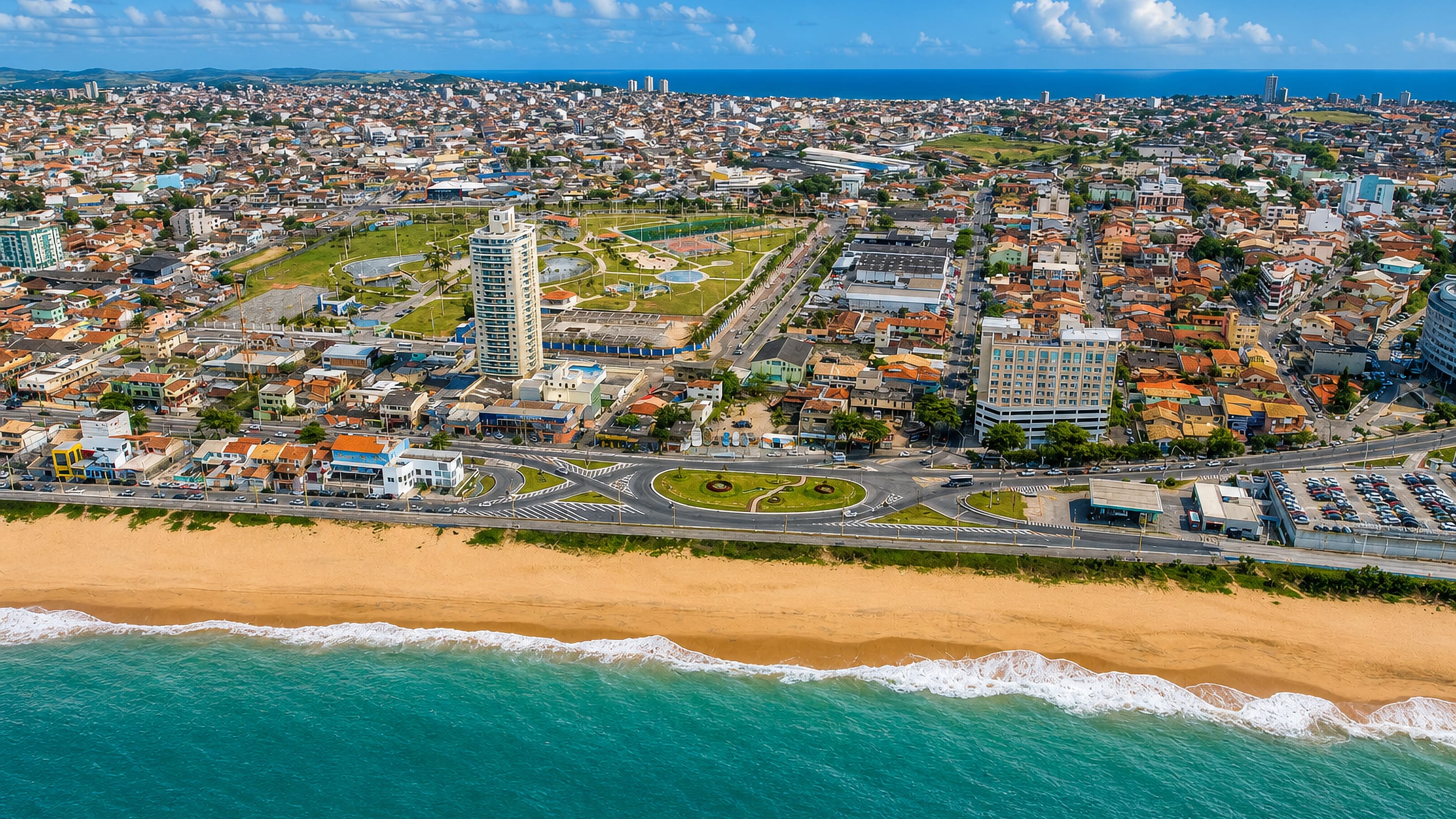 Macaé's beachfront in Rio de Janeiro state, its wide sand strip and coastal avenue fronting dense low-rise blocks.
