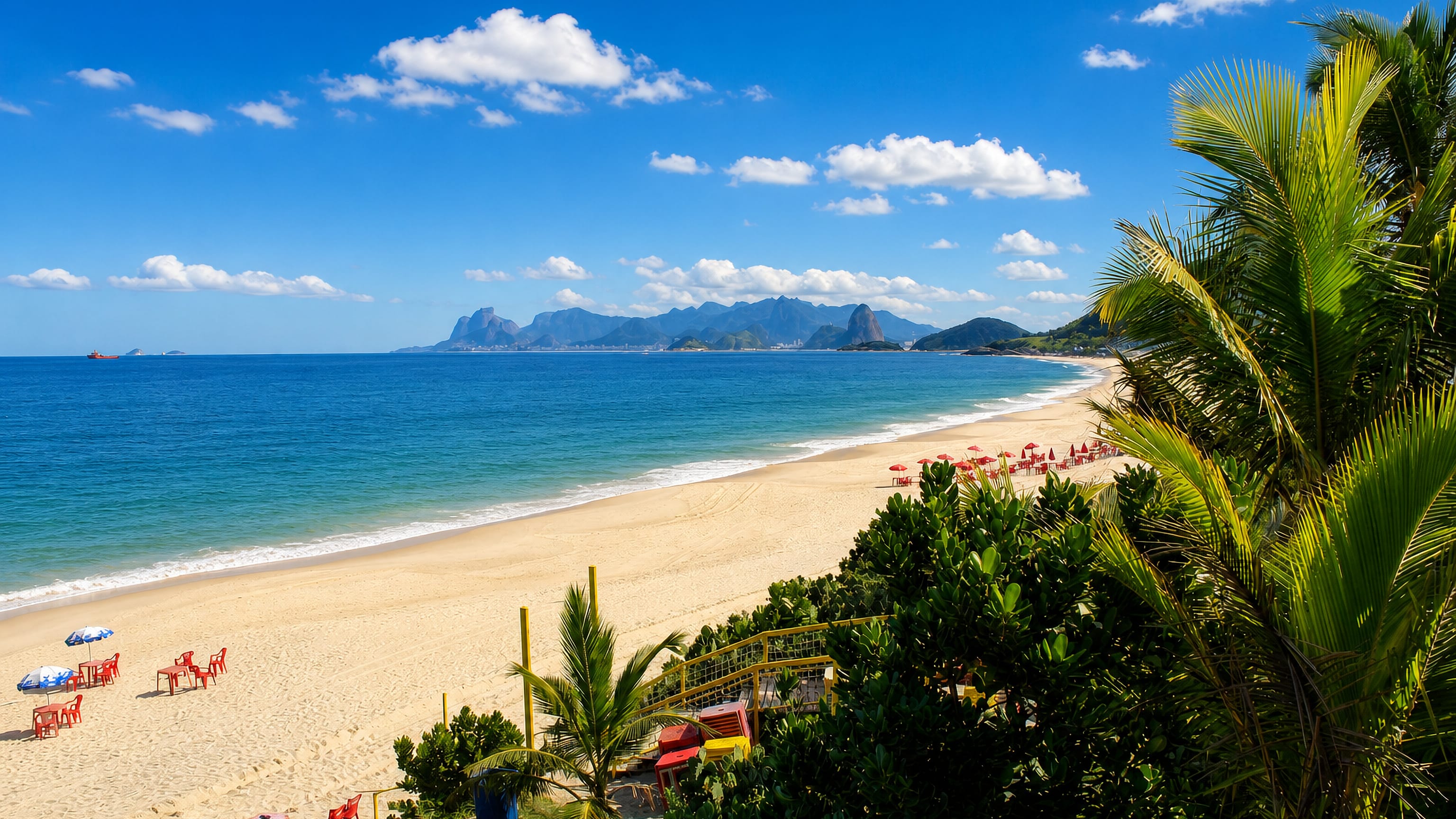 Camboinhas beach in Niterói, its curving golden sand and palms facing Rio de Janeiro's mountains across the bay.