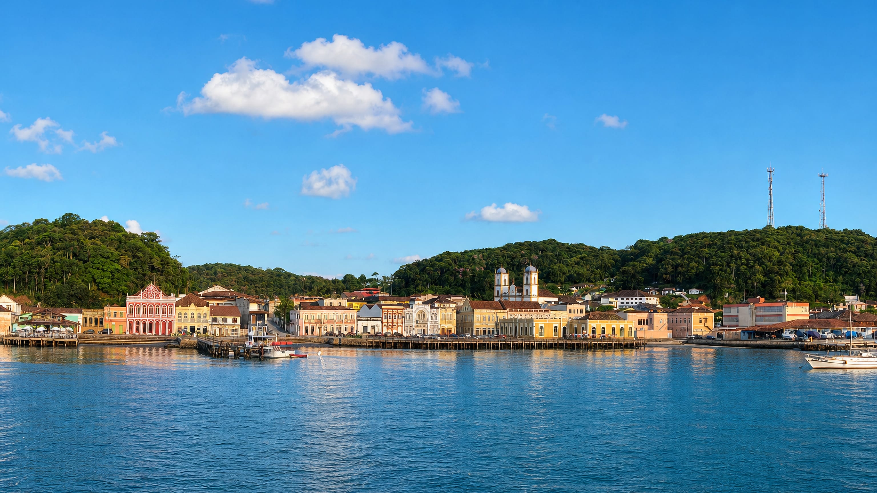 Pastel colonial waterfront and twin-towered church of São Francisco do Sul, Santa Catarina, seen from the bay.