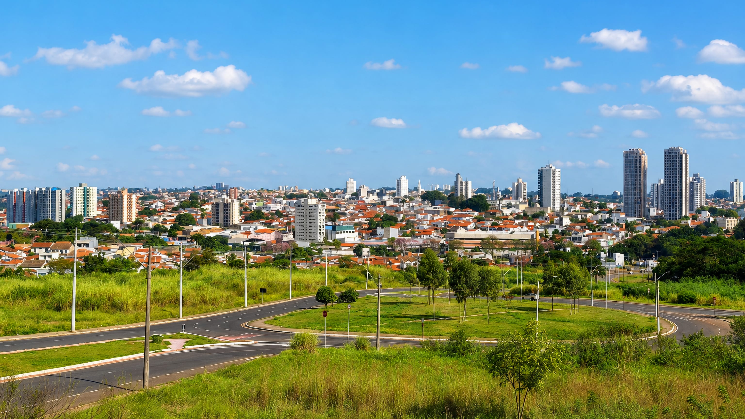 Panorama of Santa Bárbara d'Oeste, São Paulo, with red-tiled roofs and apartment towers beyond green fields