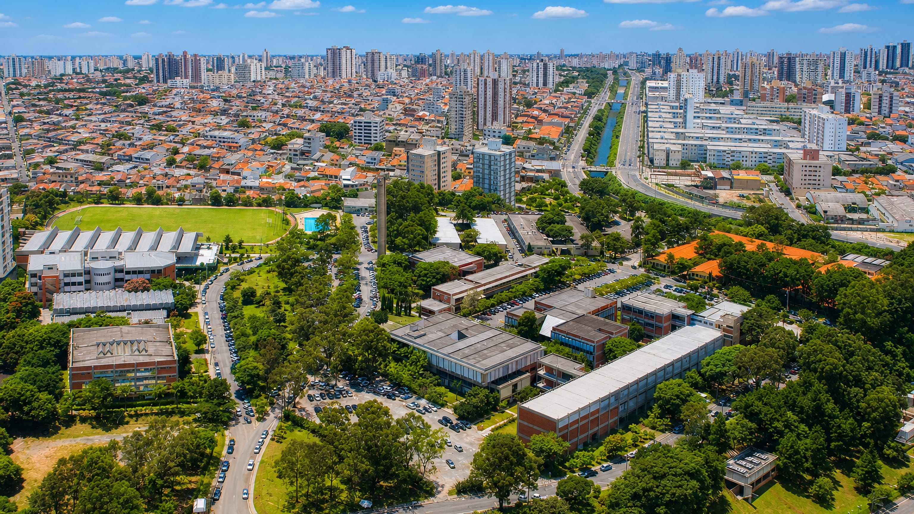 Aerial view of dense housing, apartment towers and a canal-side avenue in Sao Caetano do Sul, Brazil.