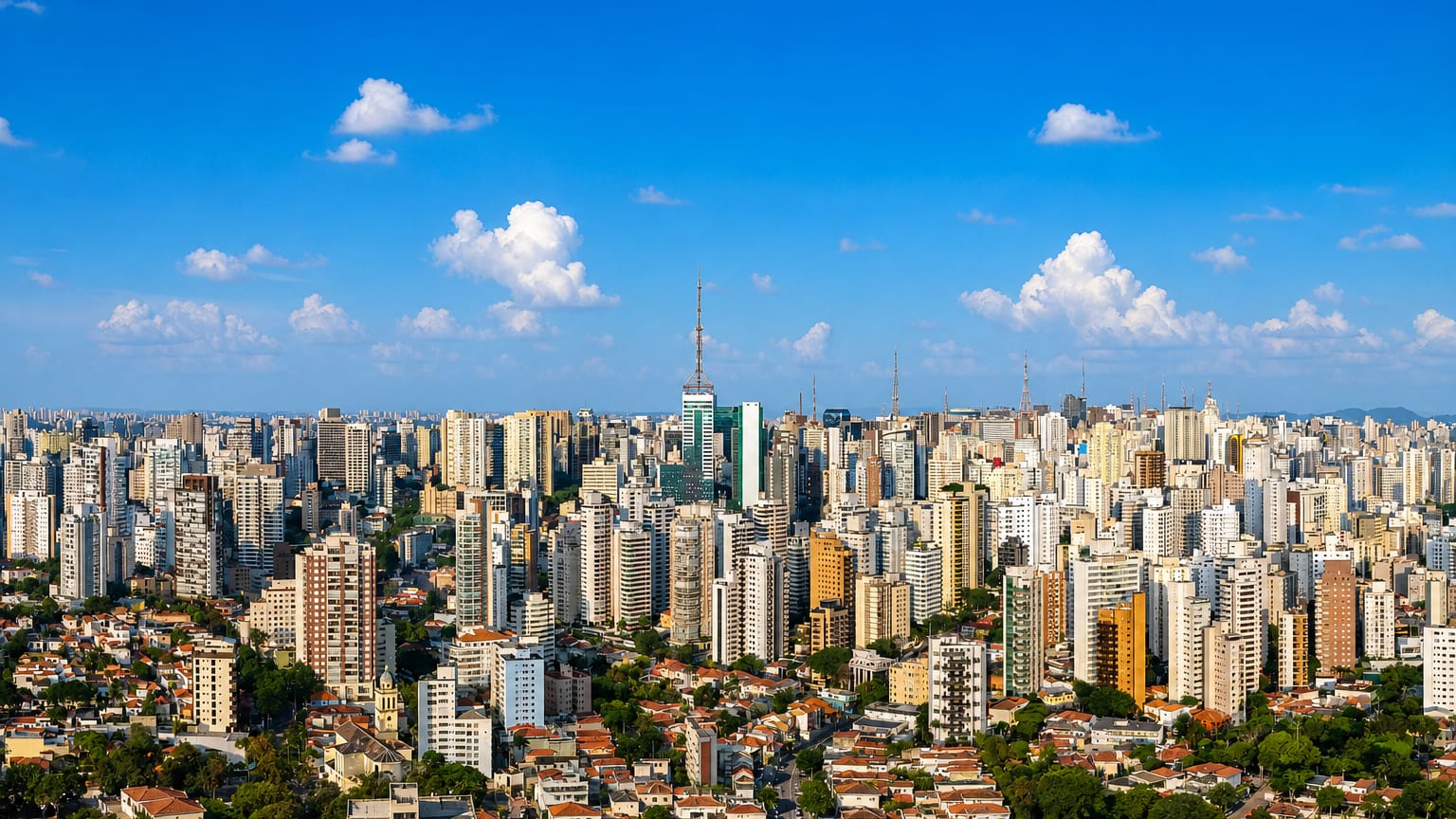 Sao Paulo's dense sea of highrise apartment towers stretching to the horizon above red-tiled rooftops.