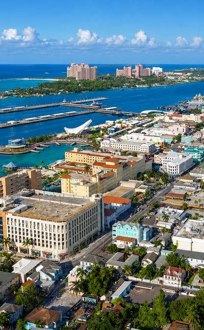 Aerial view of Nassau's harbour, colourful downtown and cruise piers with Paradise Island beyond.