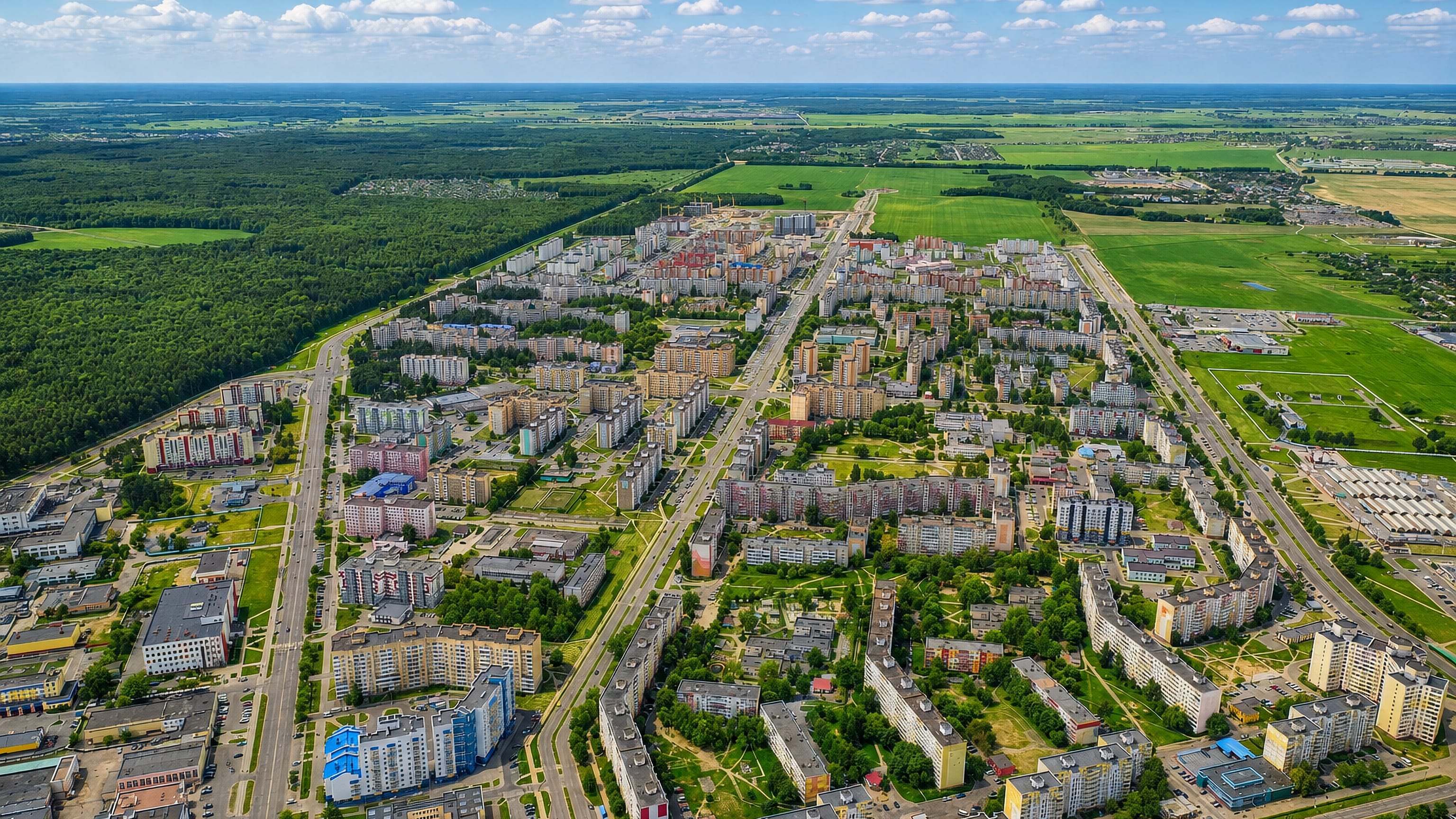 Aerial view of Soligorsk, Belarus, its mid-rise apartment blocks bounded by pine forest and open farmland.