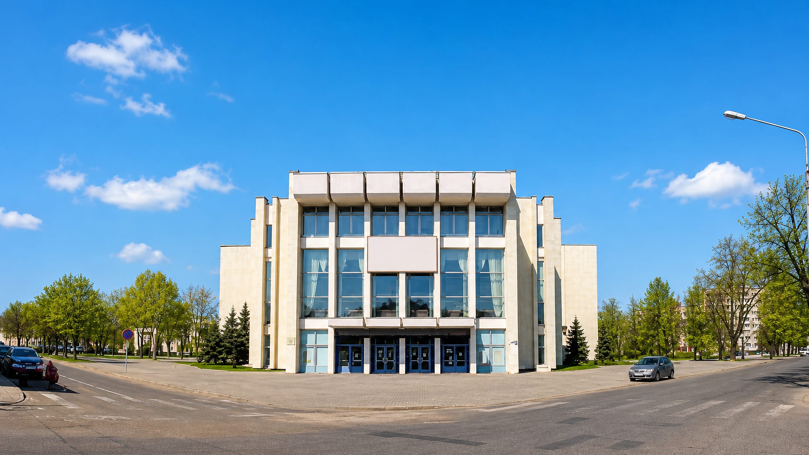 Soviet-era modernist culture palace on a wide, quiet boulevard corner in Bobruysk, Belarus