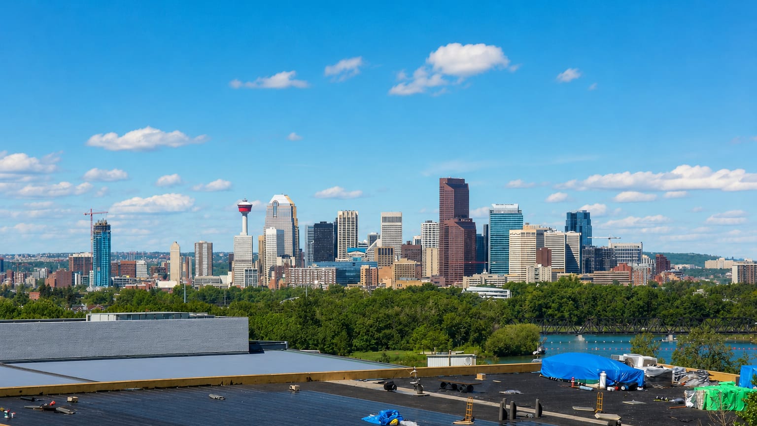 The downtown Calgary skyline with the Calgary Tower seen across rooftops from Albert Park/Radisson Heights