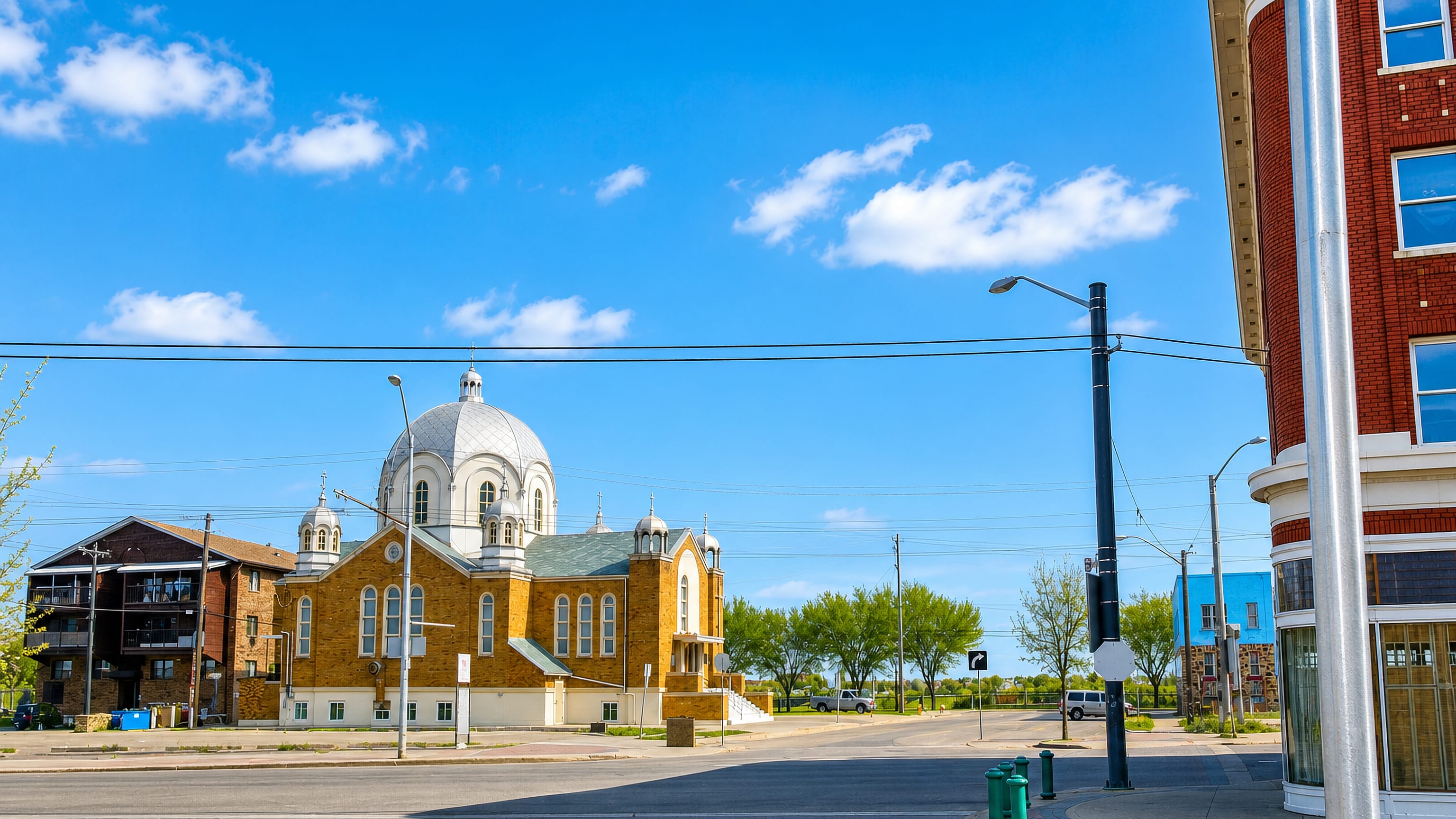 A silver-domed Ukrainian Catholic cathedral and red-brick corner block on a quiet street in Boyle Street, Edmonton.