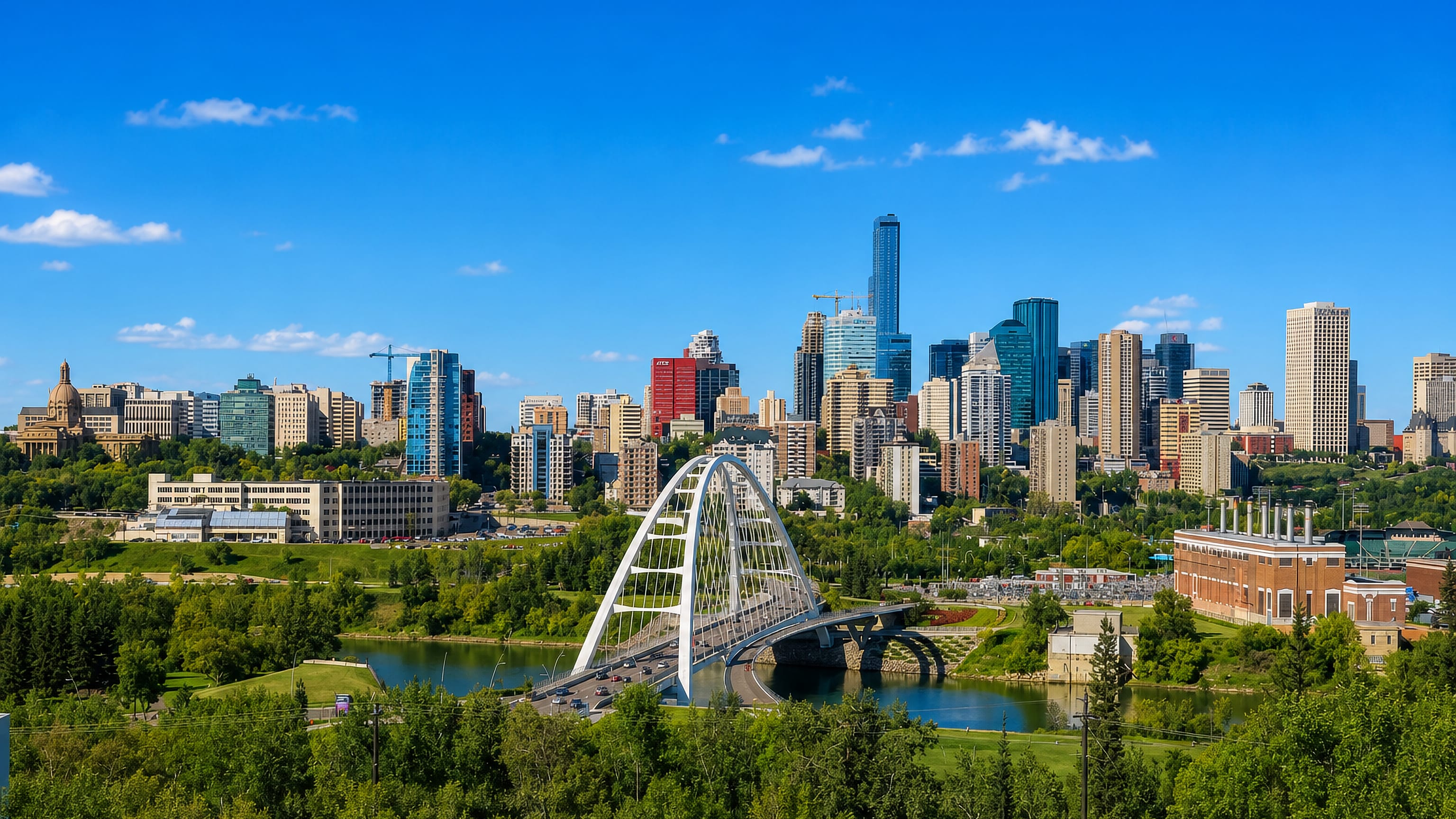Edmonton's downtown skyline behind the white Walterdale Bridge arch over the North Saskatchewan River.