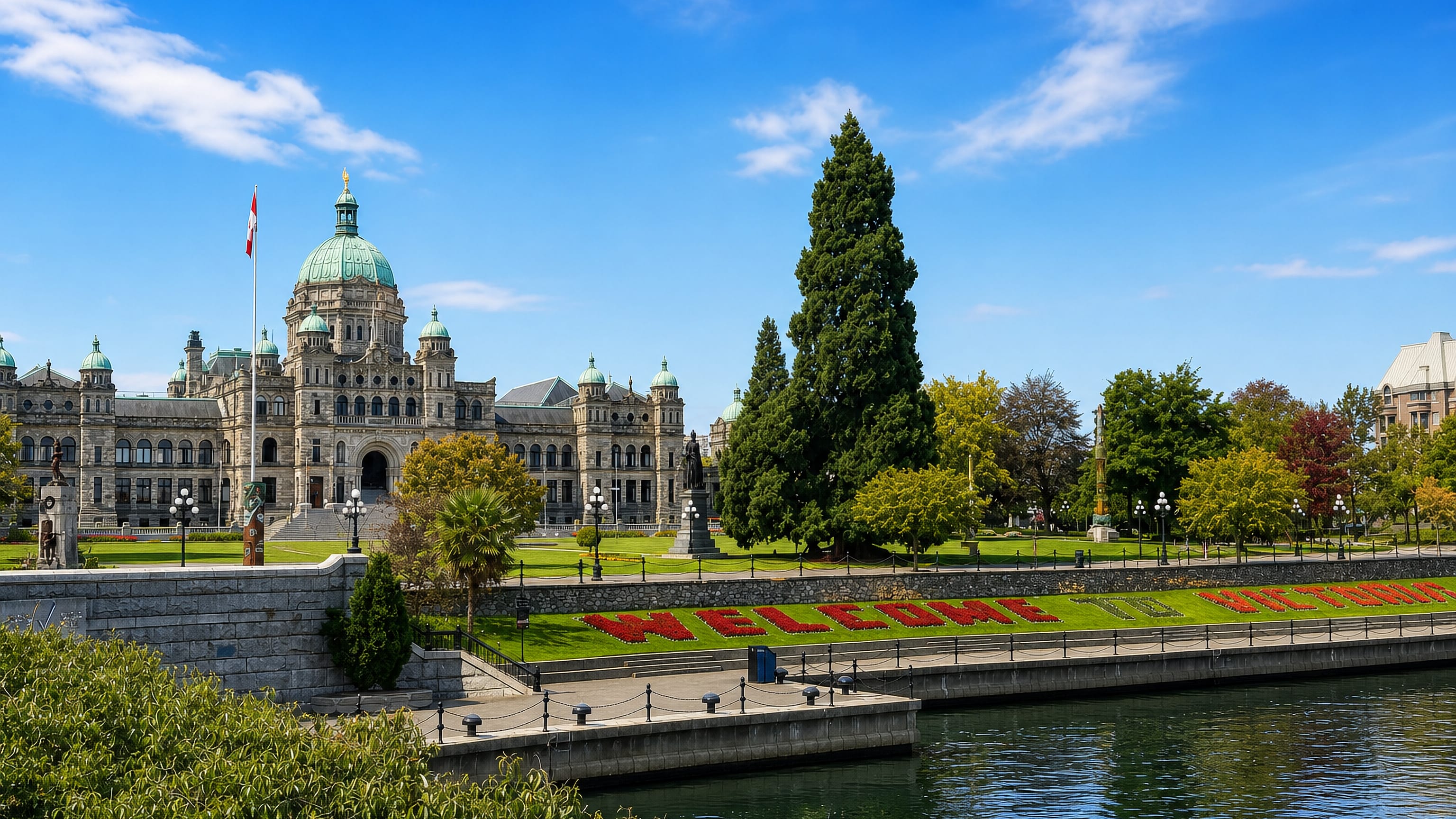 British Columbia Parliament Buildings and the Welcome to Victoria flower bed on the Inner Harbour, James Bay.
