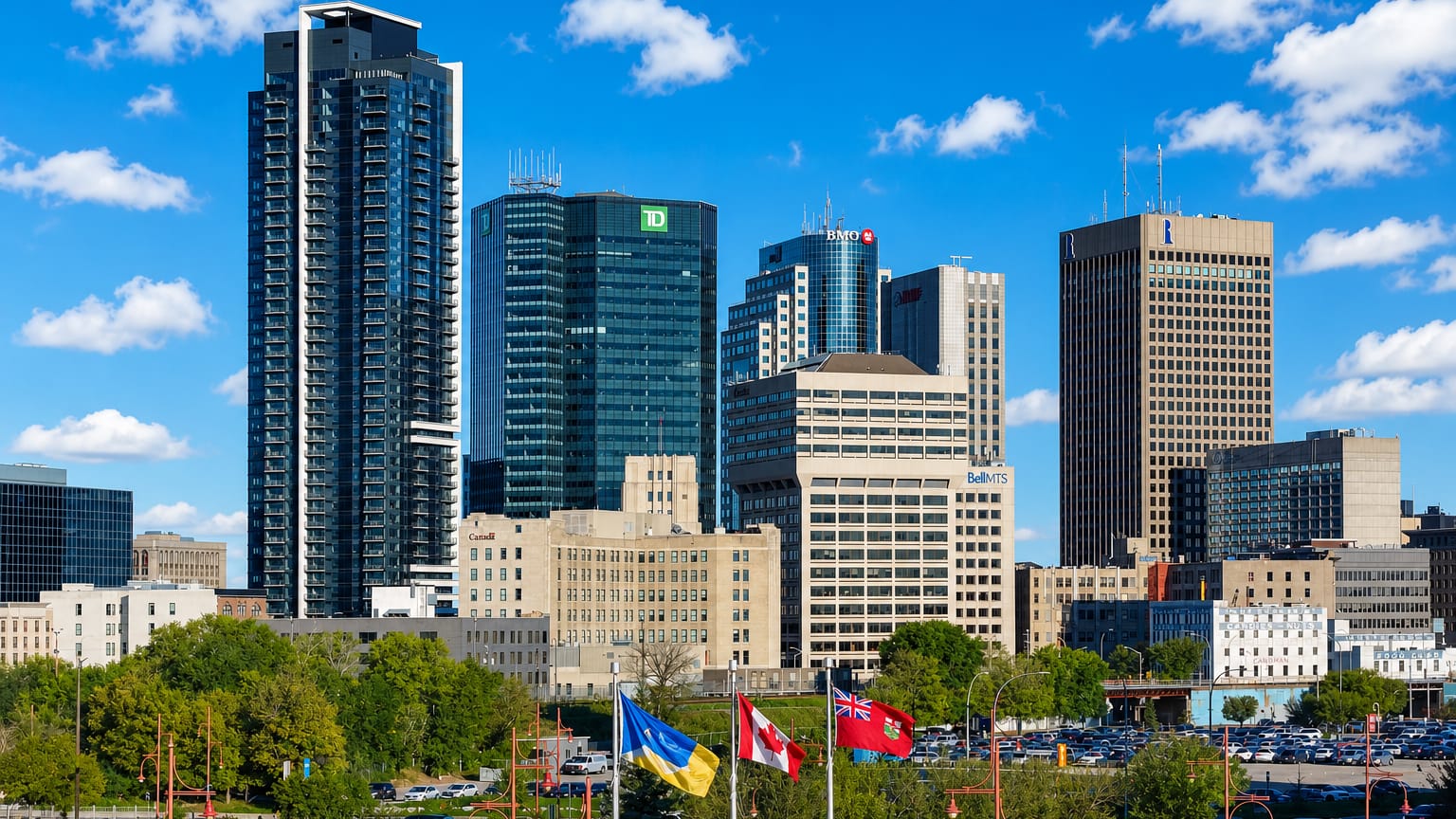 Downtown Winnipeg skyline with the TD, BMO and Richardson towers above flags on Portage Avenue.