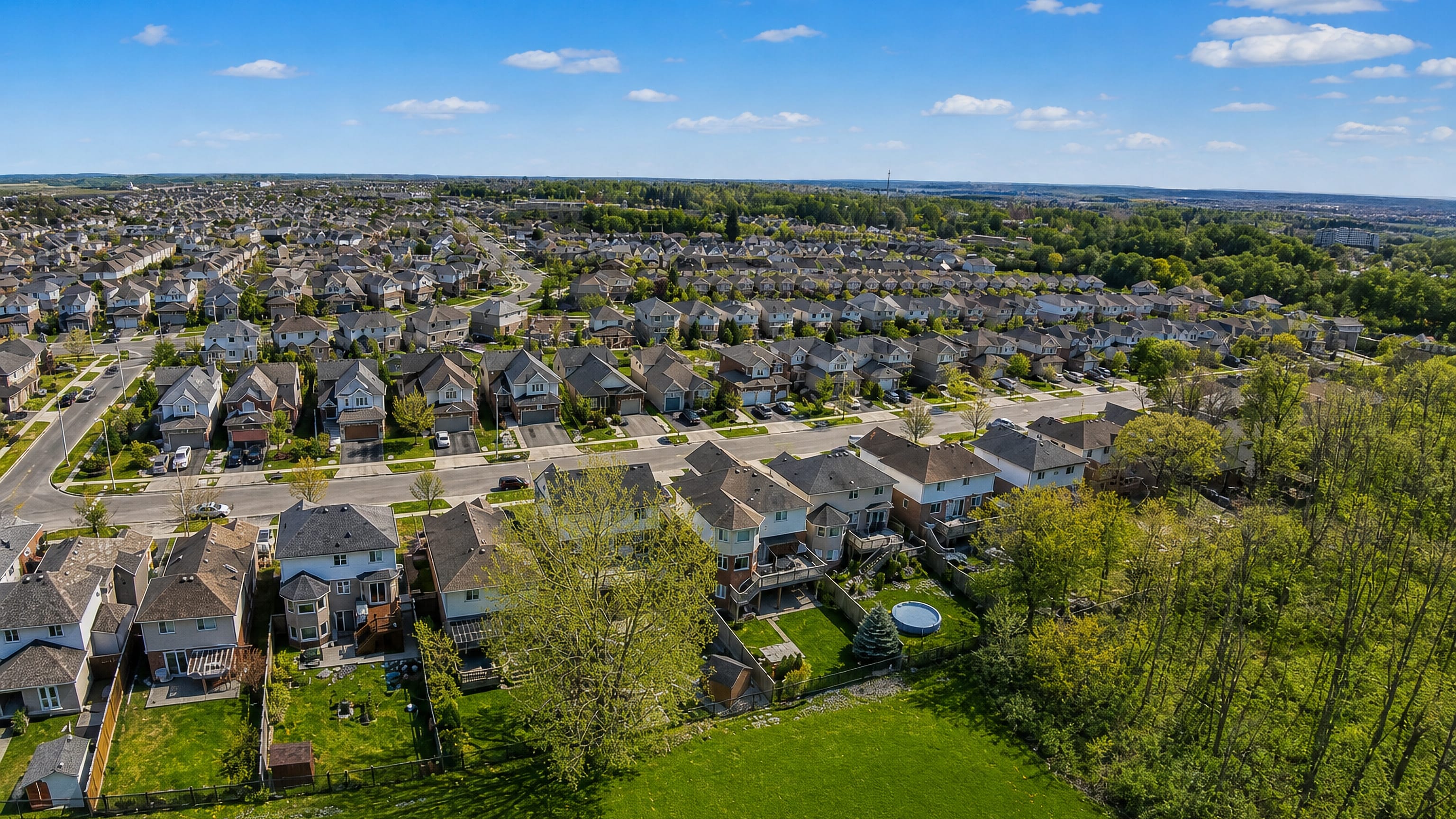 Aerial of Hespeler's newer subdivisions of detached homes and open lawns in Cambridge, Ontario