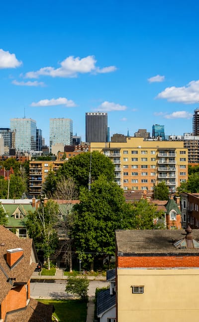 Centretown neighbourhood in Ottawa with low-rise houses and mid-rise blocks and the downtown office towers behind.