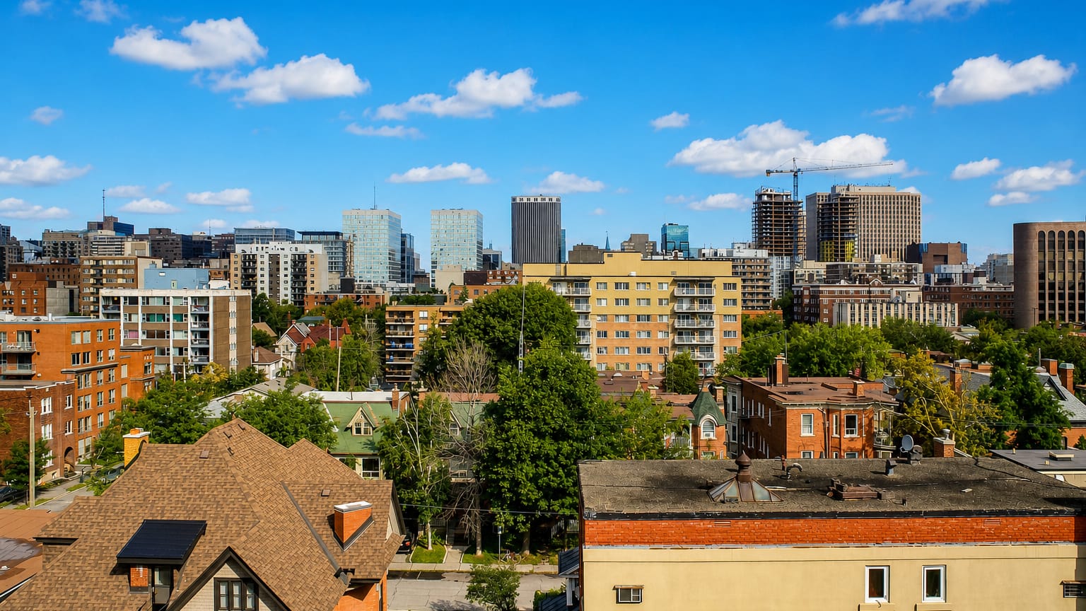 Centretown neighbourhood in Ottawa with low-rise houses and mid-rise blocks and the downtown office towers behind.