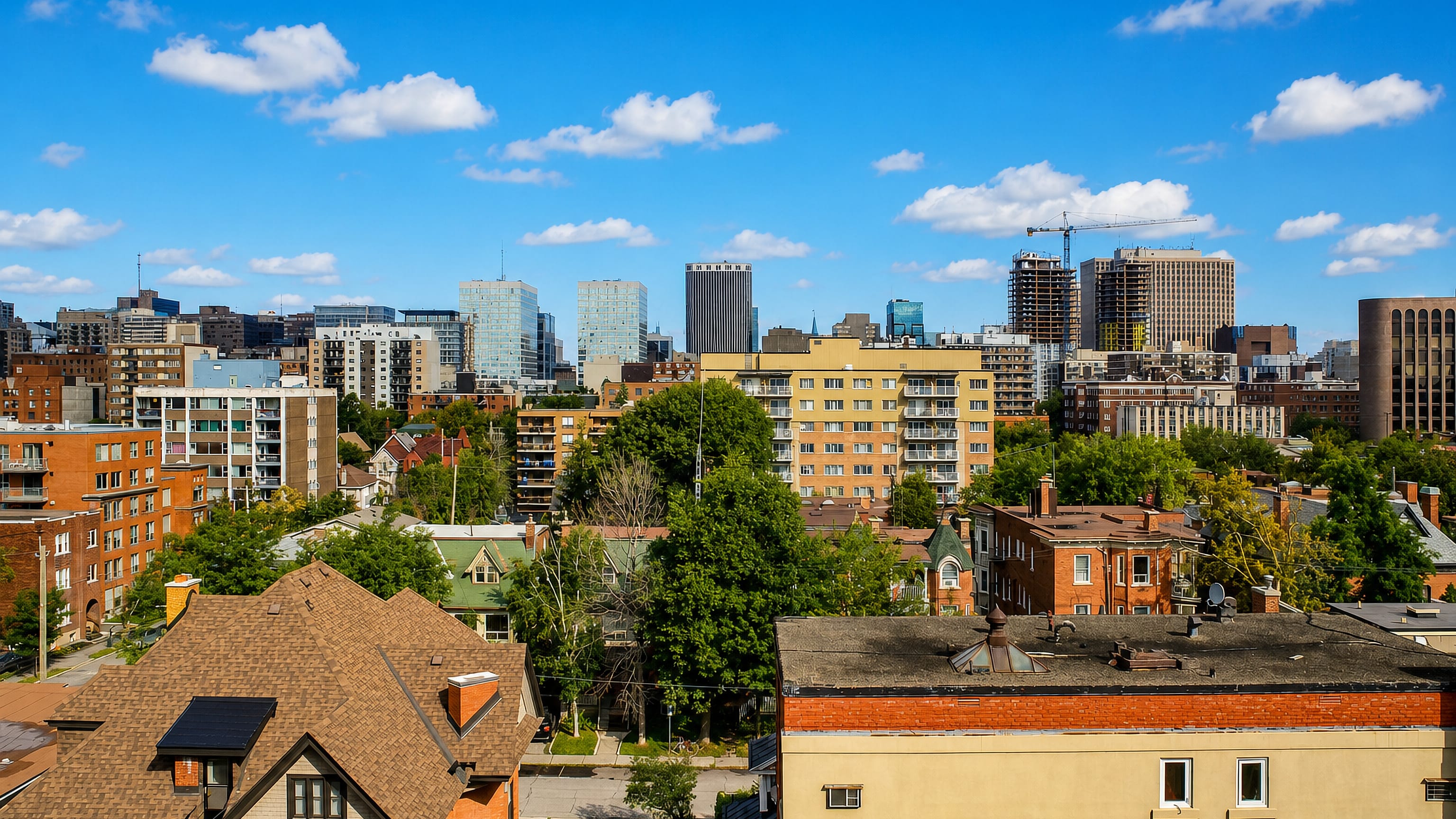 Centretown neighbourhood in Ottawa with low-rise houses and mid-rise blocks and the downtown office towers behind.