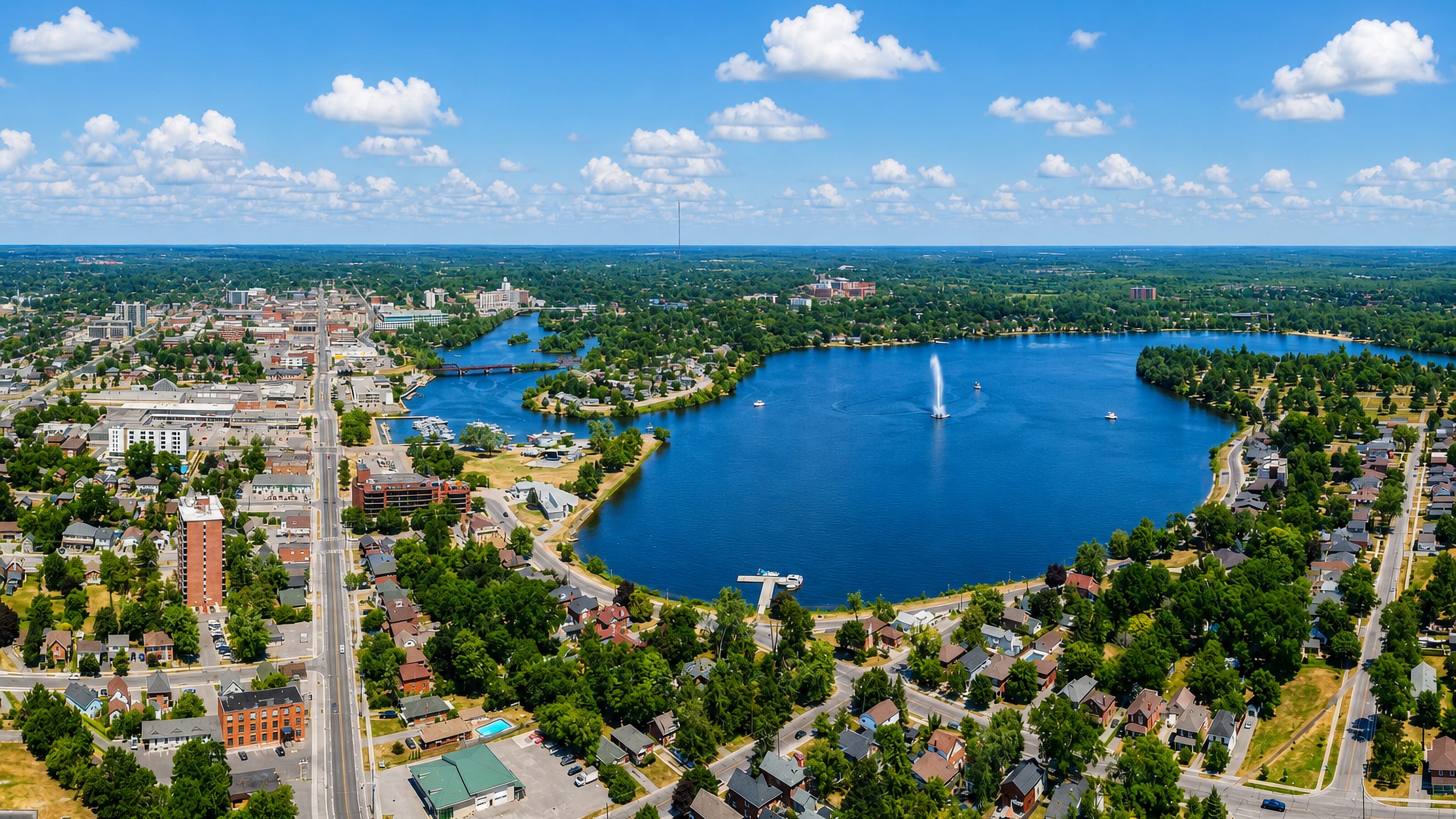 Aerial view of Peterborough, Ontario, with the fountain on Little Lake and the downtown grid beyond
