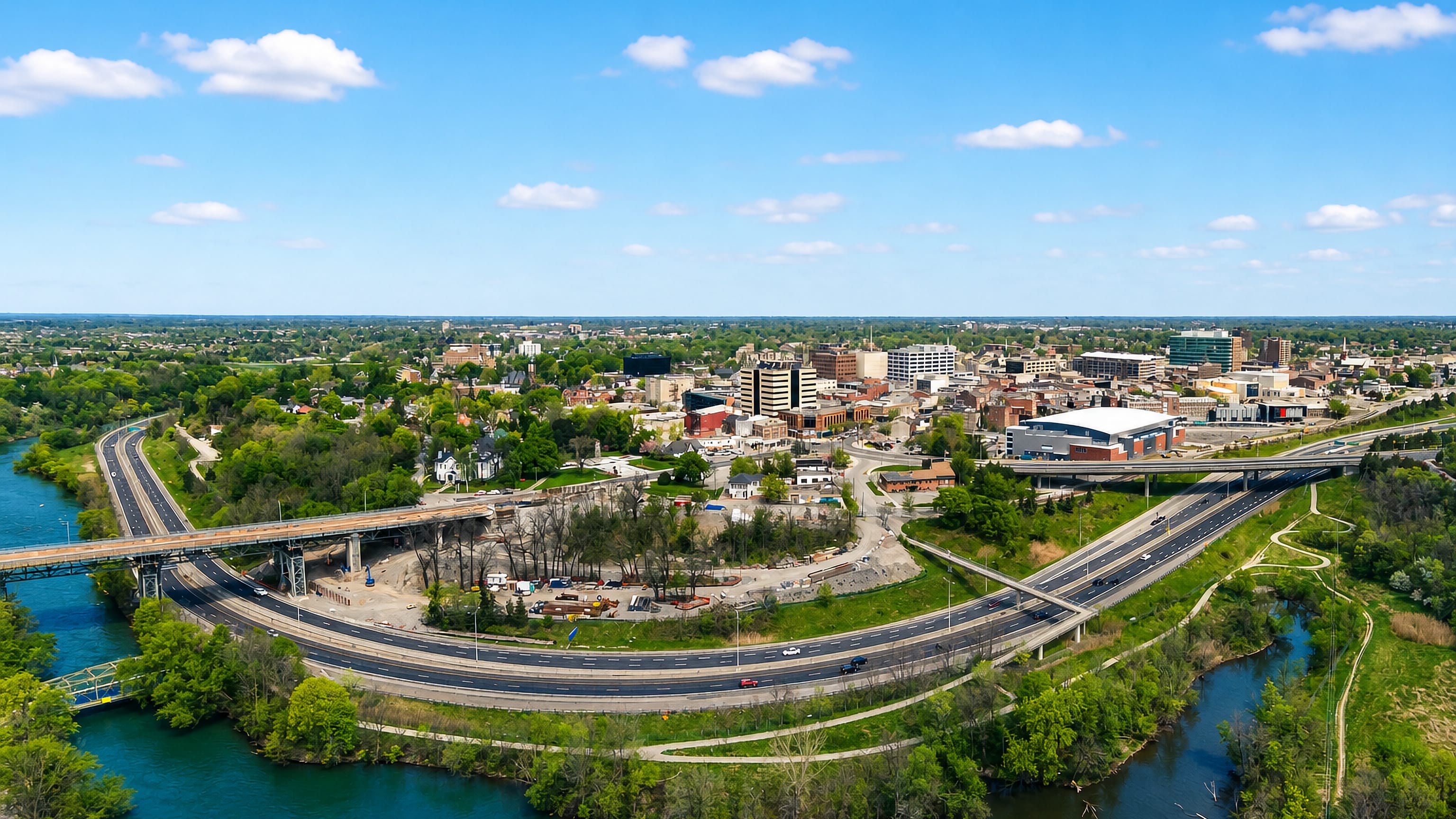 Aerial view of downtown St. Catharines, Ontario, with the highway and Twelve Mile Creek curving below.