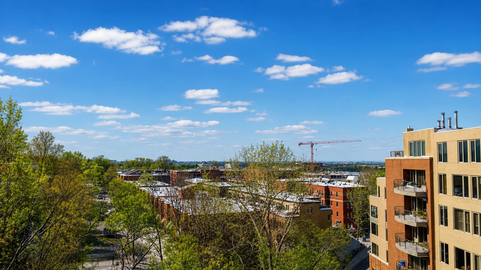 Leafy residential streets with brick low-rise apartment blocks and a construction crane in Outremont, Montreal