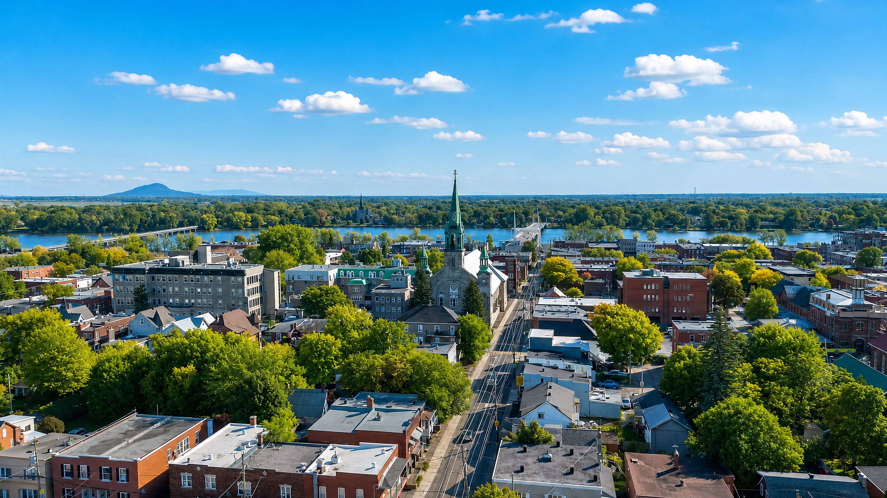 Green-spired cathedral and main street running to the Richelieu River in Saint-Jean-sur-Richelieu, Quebec.