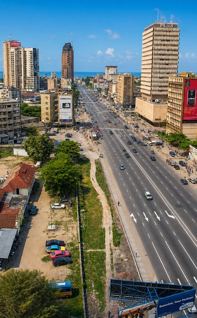 Boulevard du 30 Juin and the high-rise business district of Gombe, central Kinshasa, with the Congo River on the horizon.