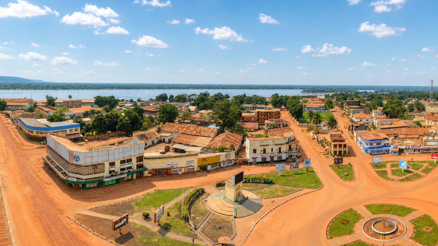 Aerial view of Bangui's central roundabout and red-earth streets beside the Ubangi River.