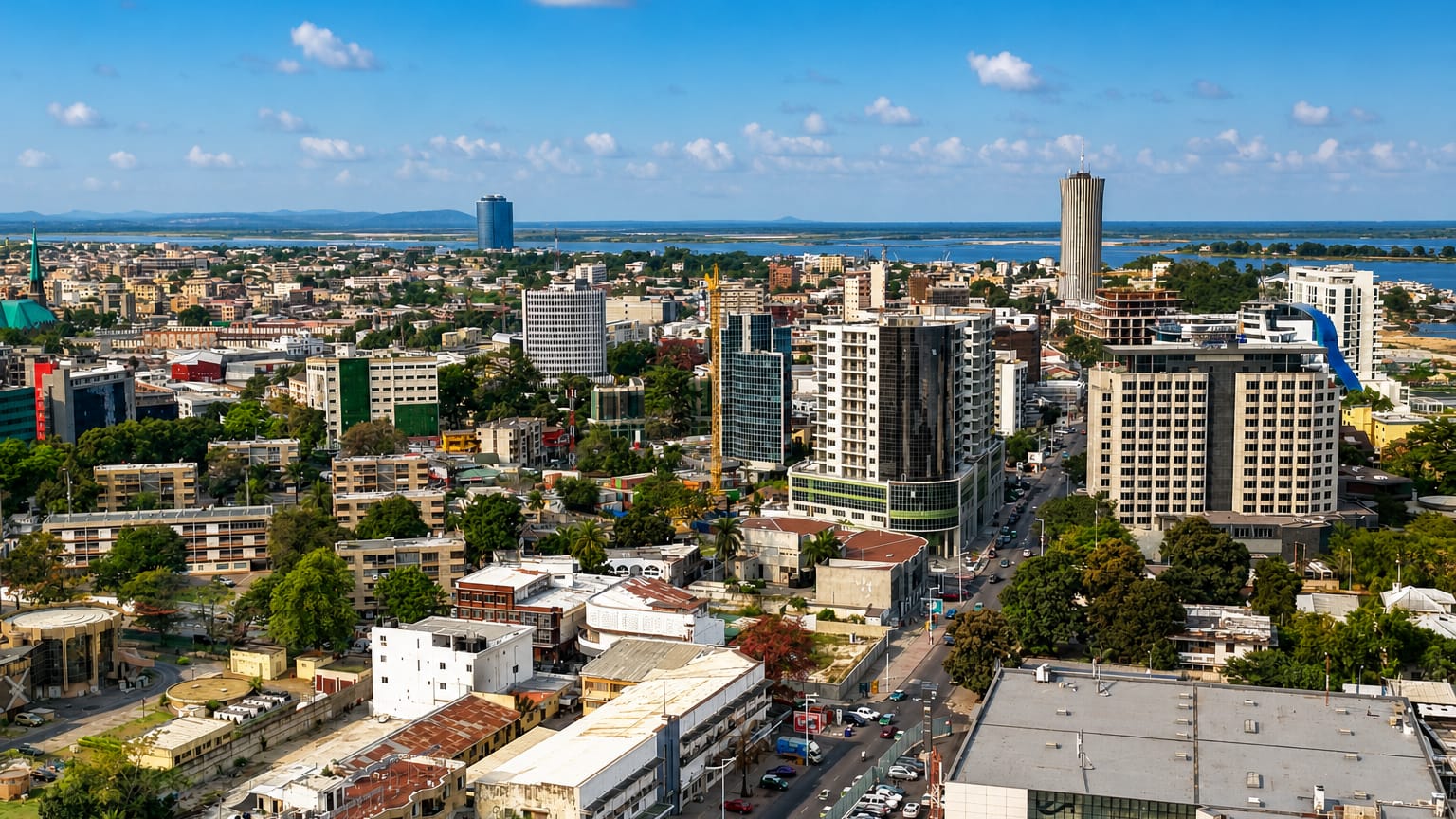Brazzaville's downtown skyline with the cylindrical Nabemba Tower rising above office blocks by the Congo River.