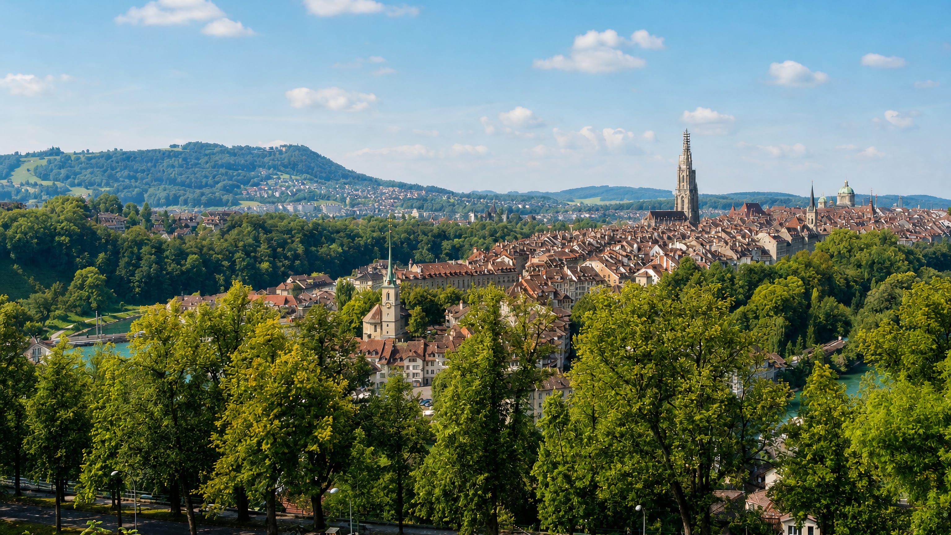 Bern's Innere Stadt old town on its Aare bend, the Münster spire rising above tiled roofs.