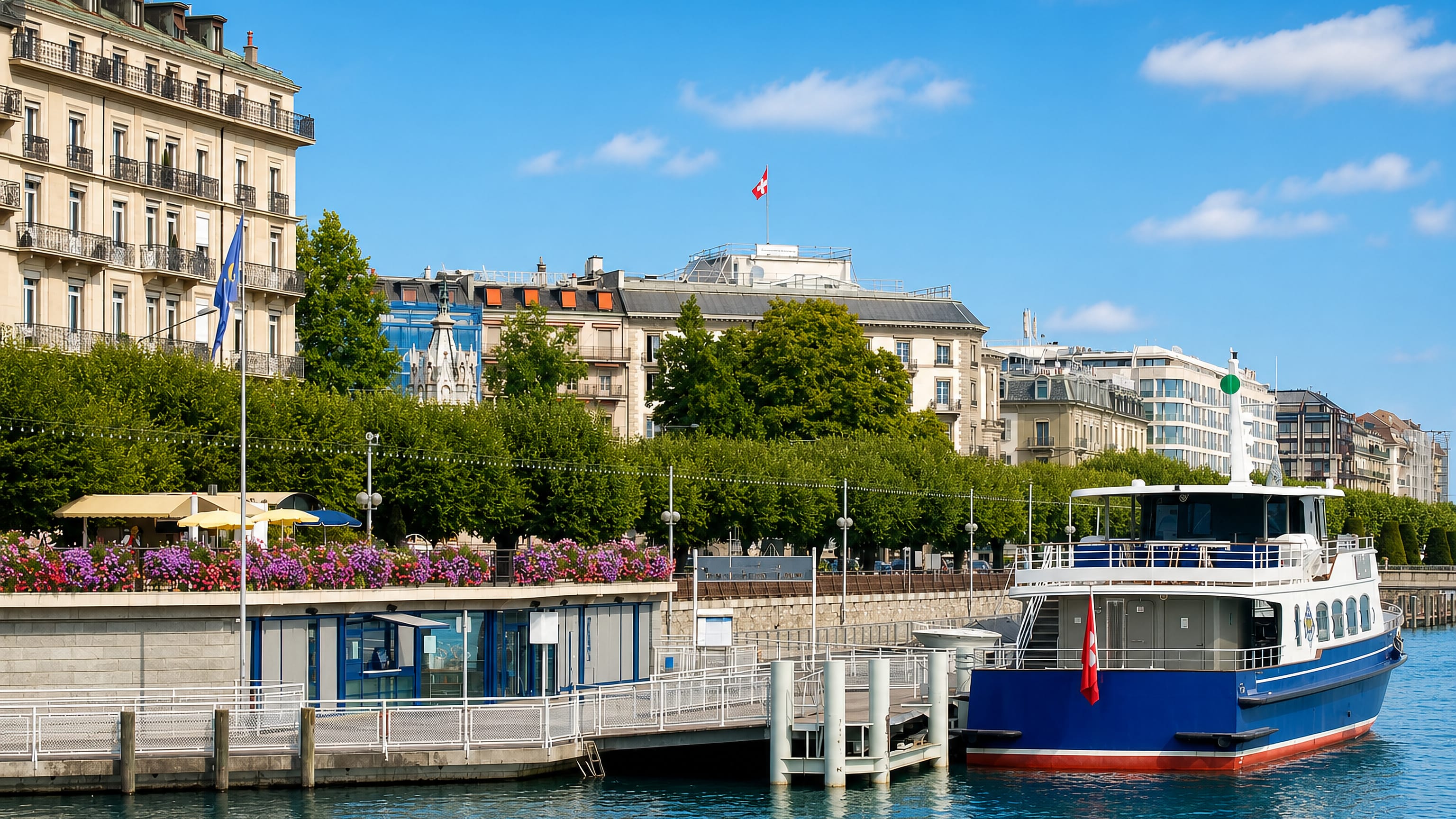 Quai du Mont-Blanc in Geneva's Pâquis district, with a lake boat, Swiss flags and Belle Epoque hotel facades.