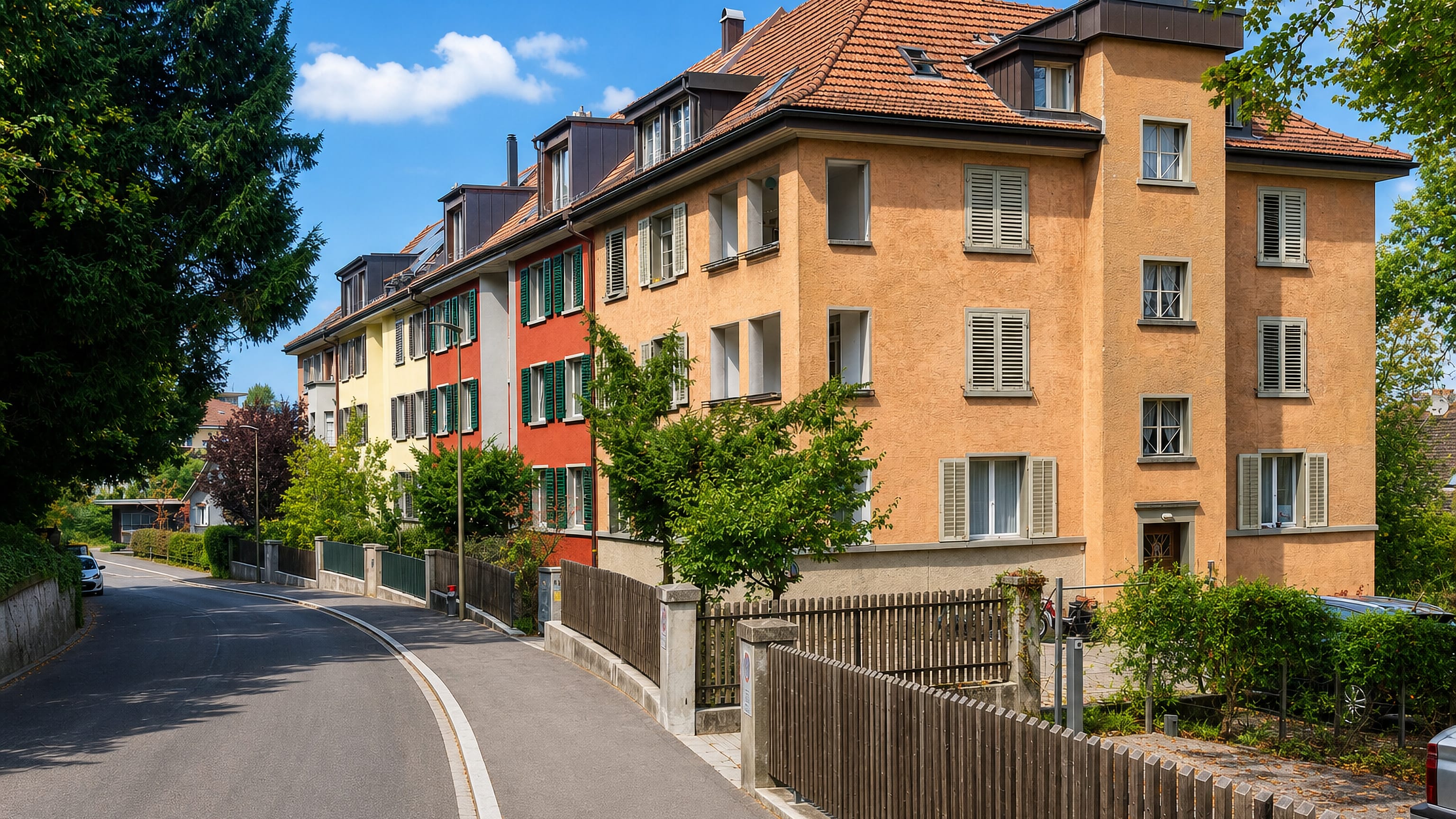 Colourful early-1900s apartment houses on a curving hillside street in Heiligberg, Winterthur, Switzerland.