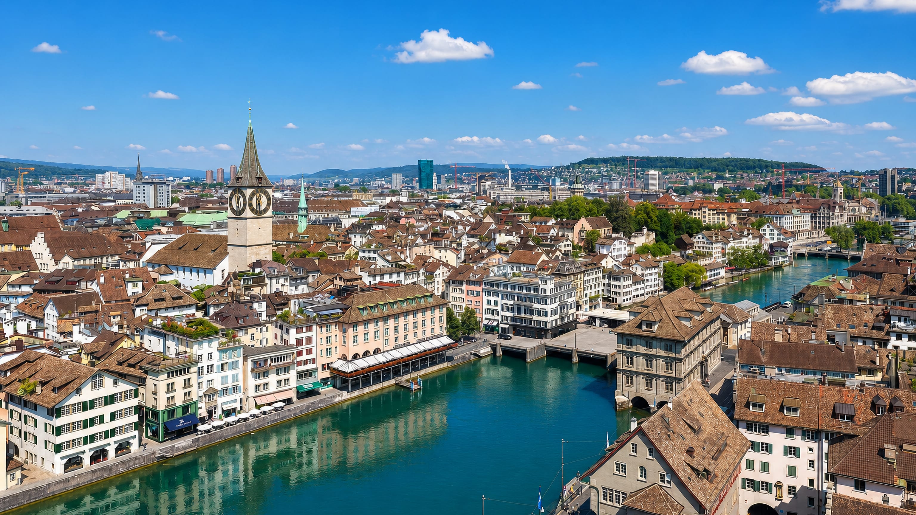Zürich old town along the Limmat with St. Peter's clock tower and the Fraumünster spire