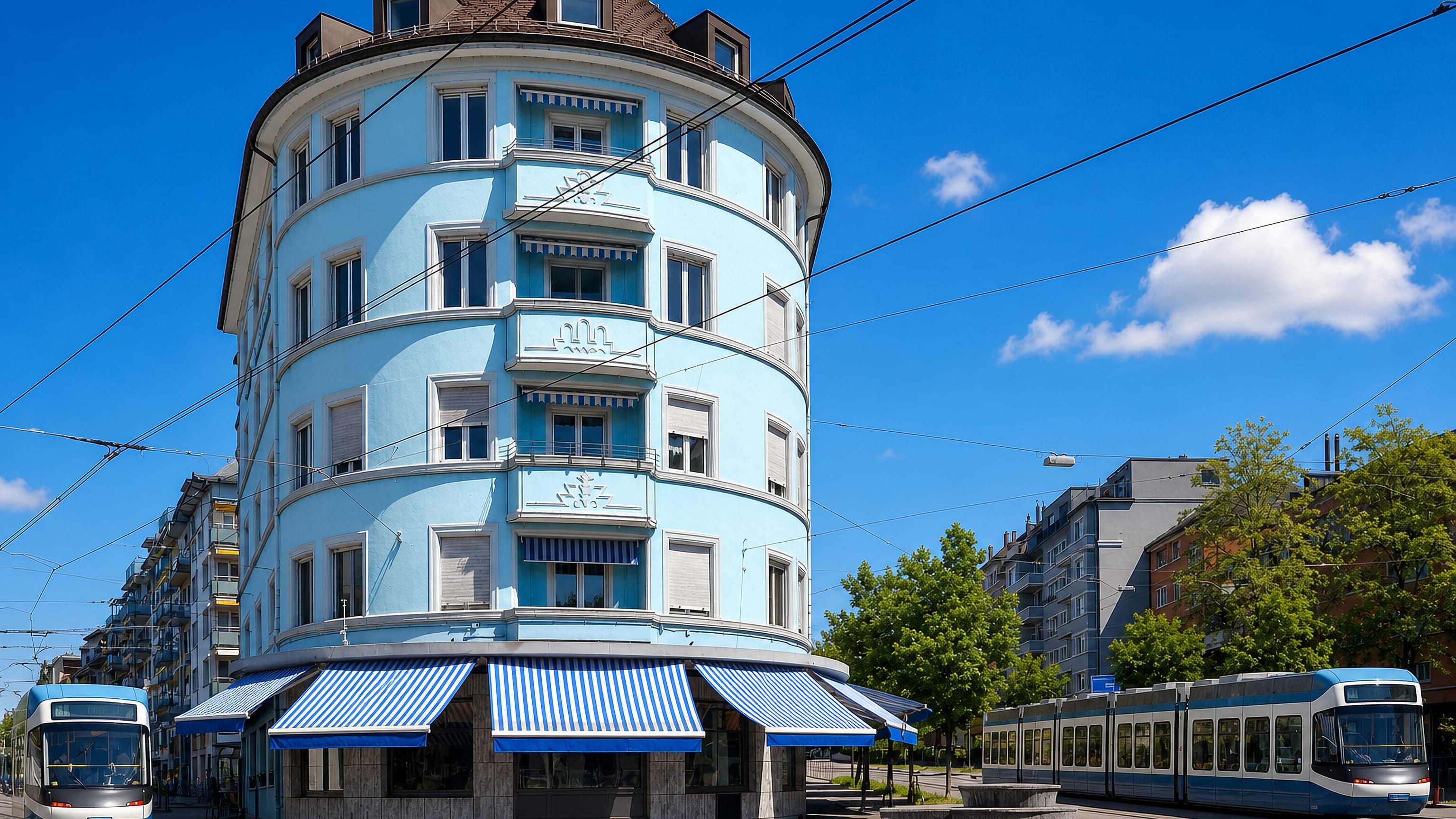 Pale blue rounded corner building with striped awnings and passing trams in Zürich's Unterstrass, Kreis 6