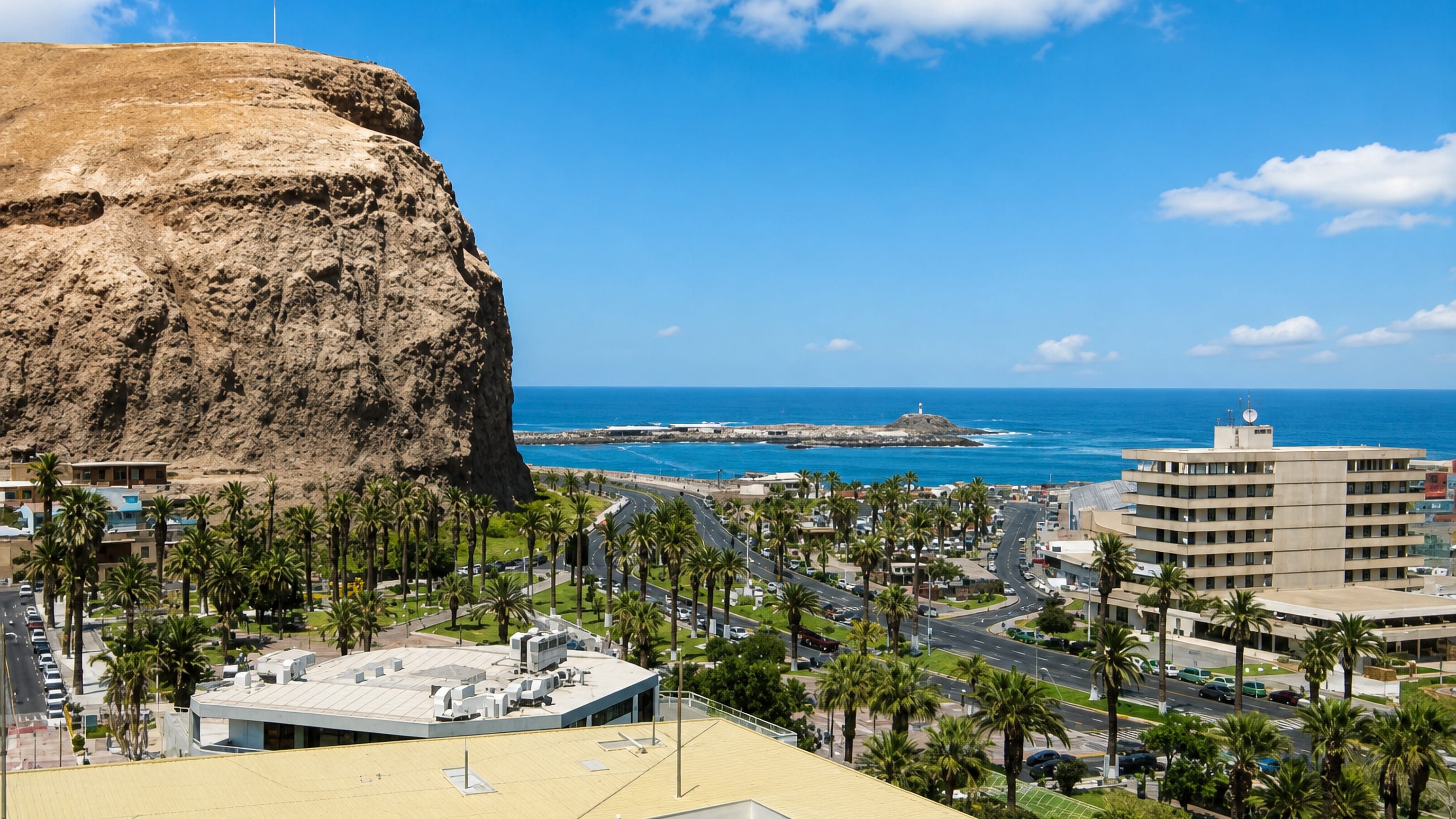El Morro de Arica flying the Chilean flag above the city's palm-lined avenues and the Pacific coast.