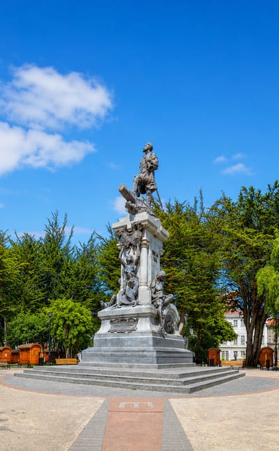 The Magellan monument in the tree-lined main plaza of Punta Arenas, Chile.
