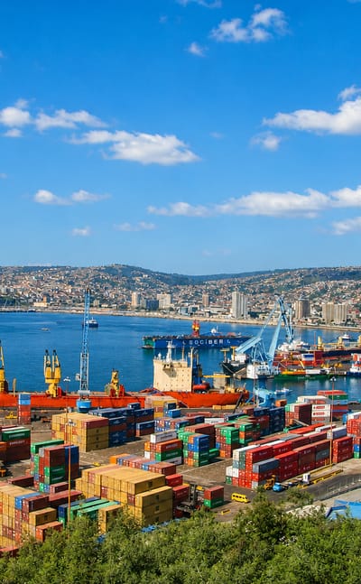 The busy container port and hillside houses ringing the bay of Valparaiso, Chile.