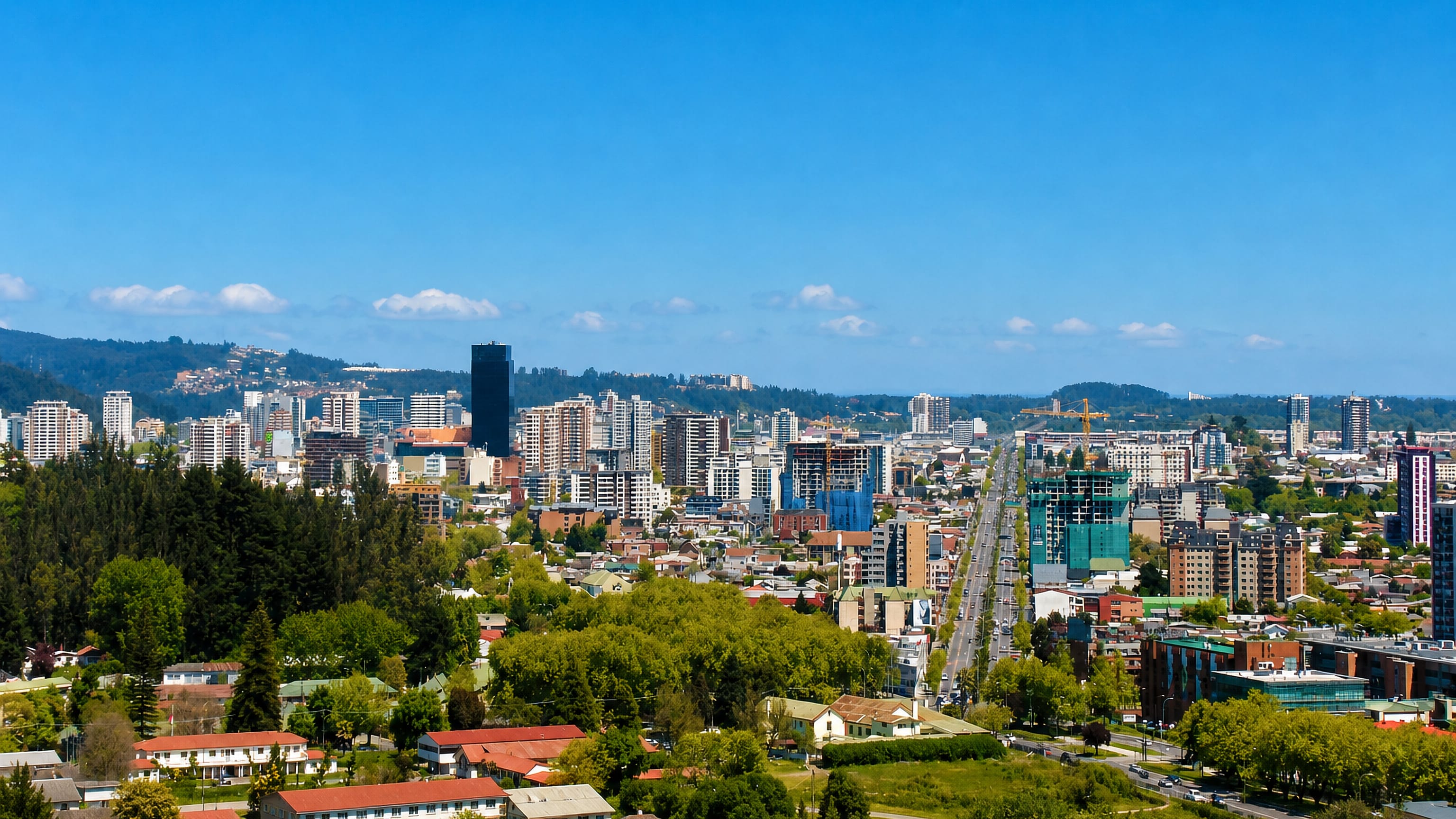 Concepcion, Chile's downtown towers and tile-roofed neighbourhoods spread below wooded hills of the Biobio region.