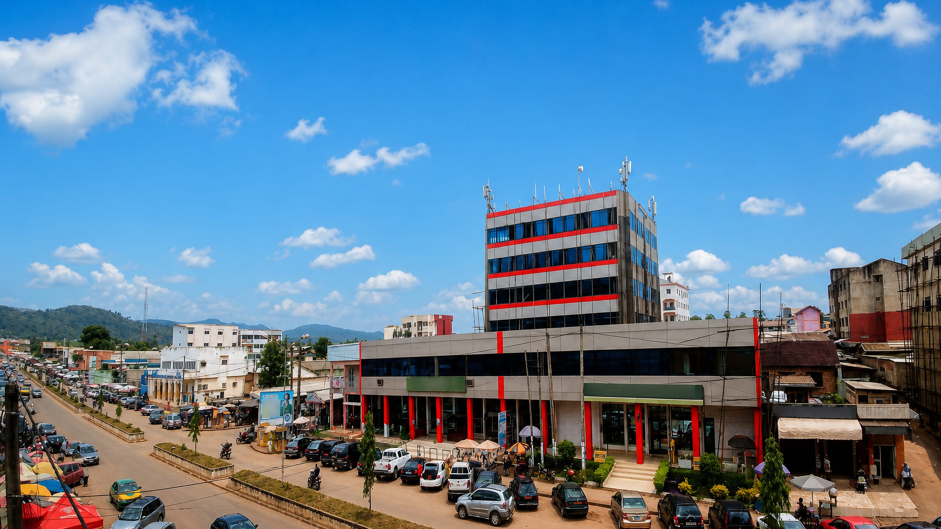 Commercial Avenue in Bamenda, Cameroon, lined with shops and offices below the green hills of the North-West.