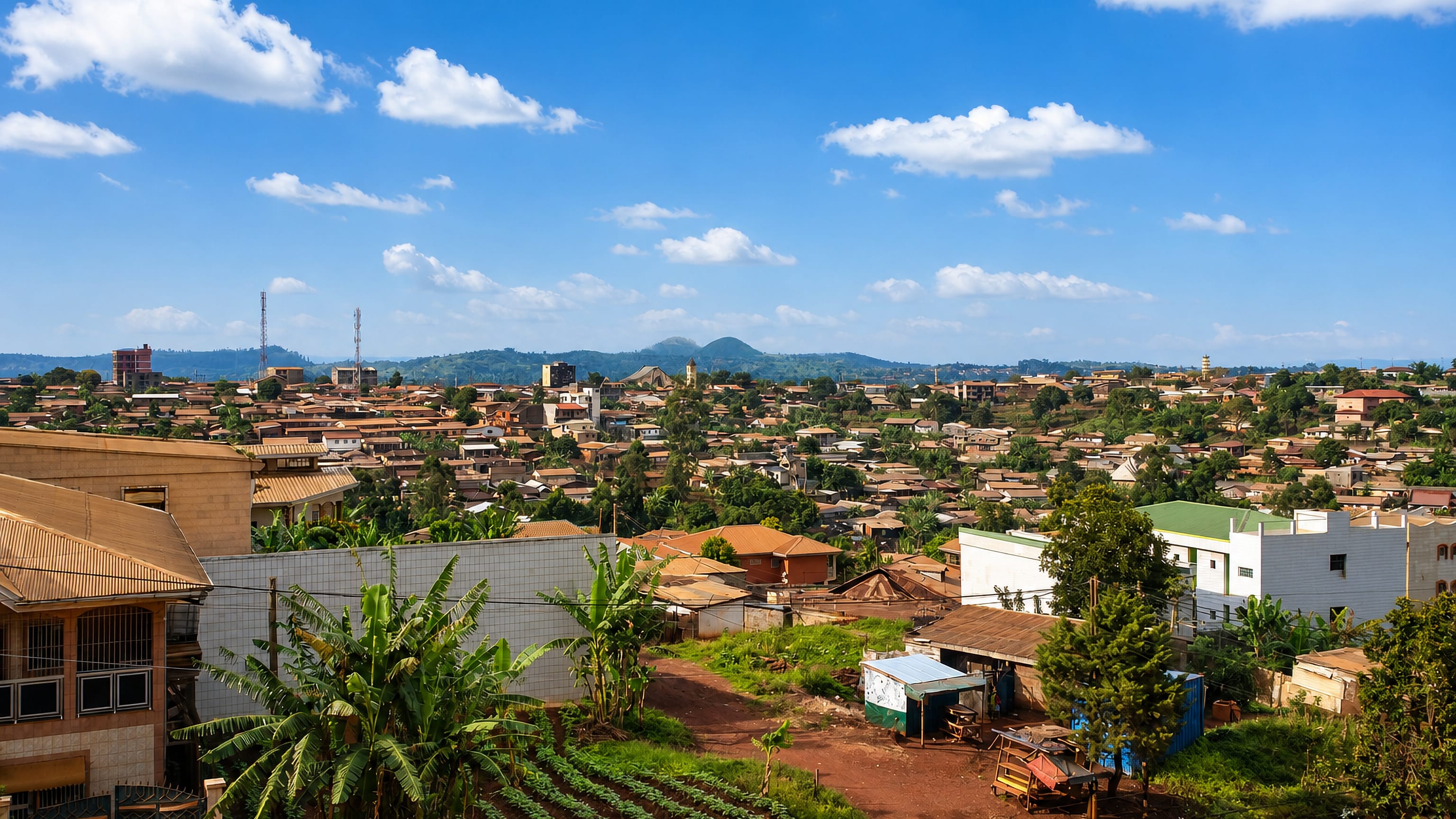 Tin-roofed houses spreading over the red-earth hills of Bafoussam in Cameroon's western highlands