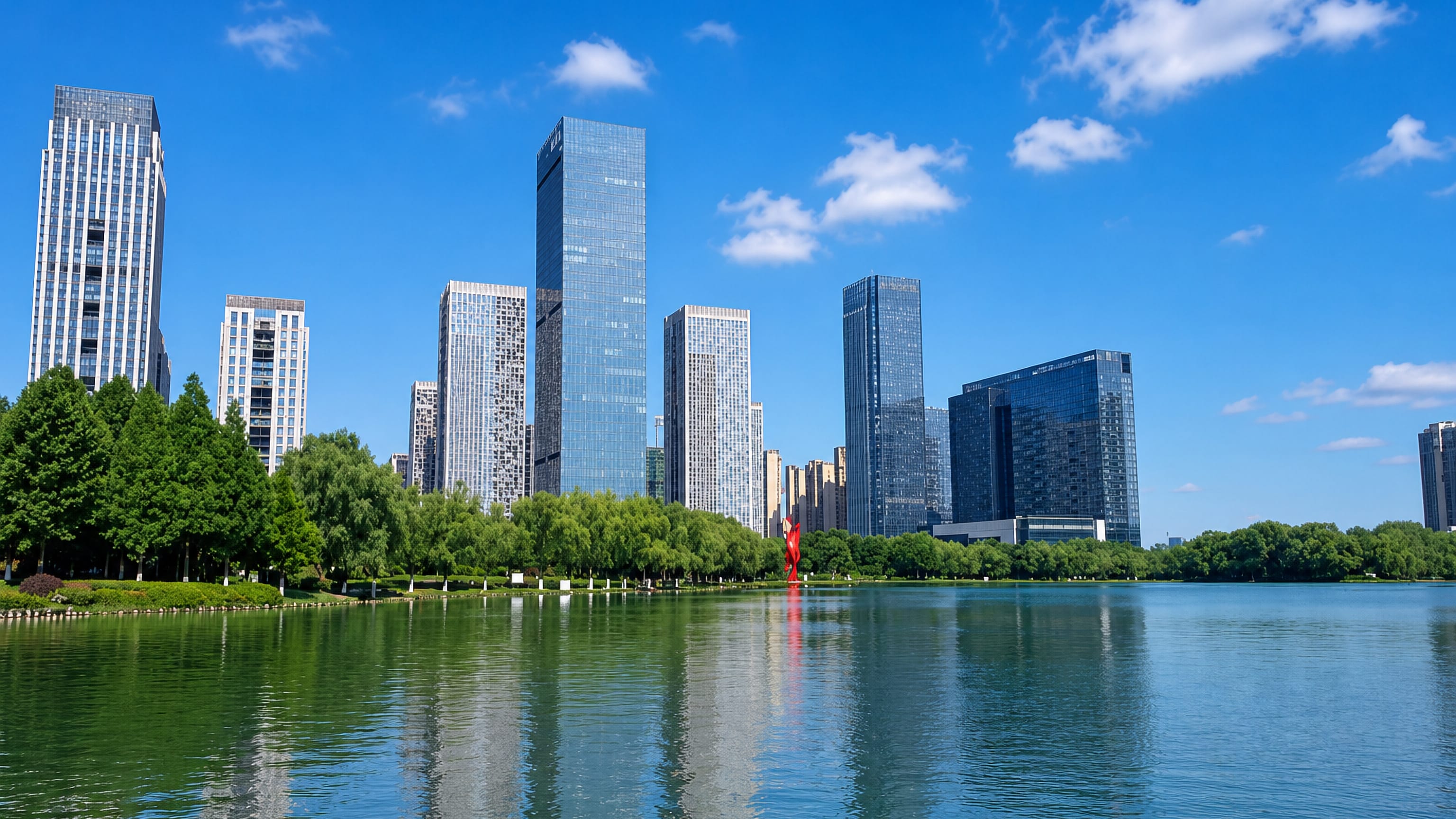 Hefei's Swan Lake CBD towers reflected in the lake behind willow-lined parkland in Anhui, China