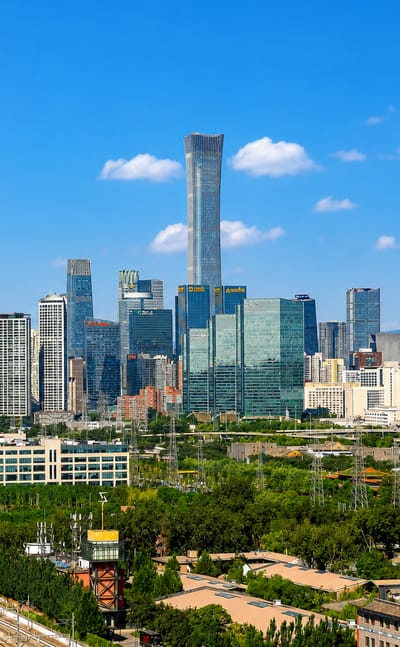 Beijing CBD skyline centred on the tapered CITIC Tower amid the Guomao cluster with greenery in the foreground