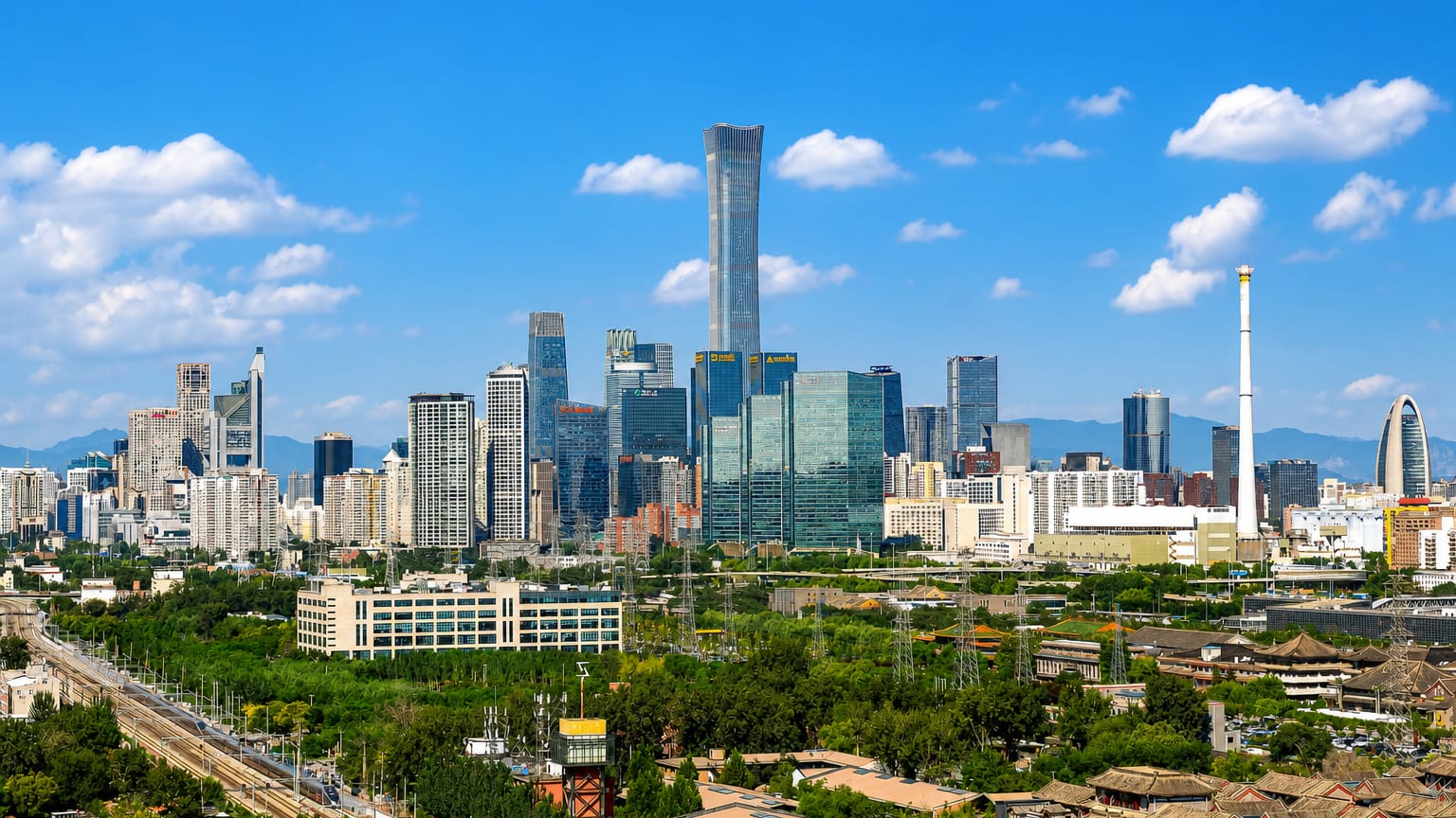 Beijing CBD skyline centred on the tapered CITIC Tower amid the Guomao cluster with greenery in the foreground