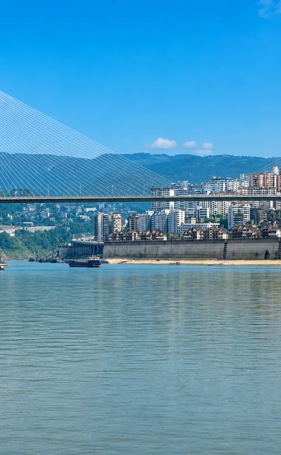 Cable-stayed bridge over the Yangtze River with riverside high-rises and mountains in Fuling, Chongqing