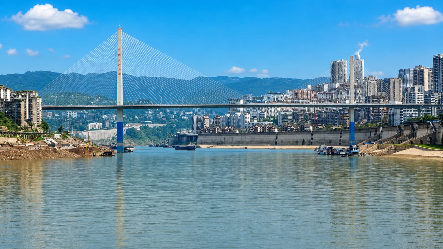 Cable-stayed bridge over the Yangtze River with riverside high-rises and mountains in Fuling, Chongqing