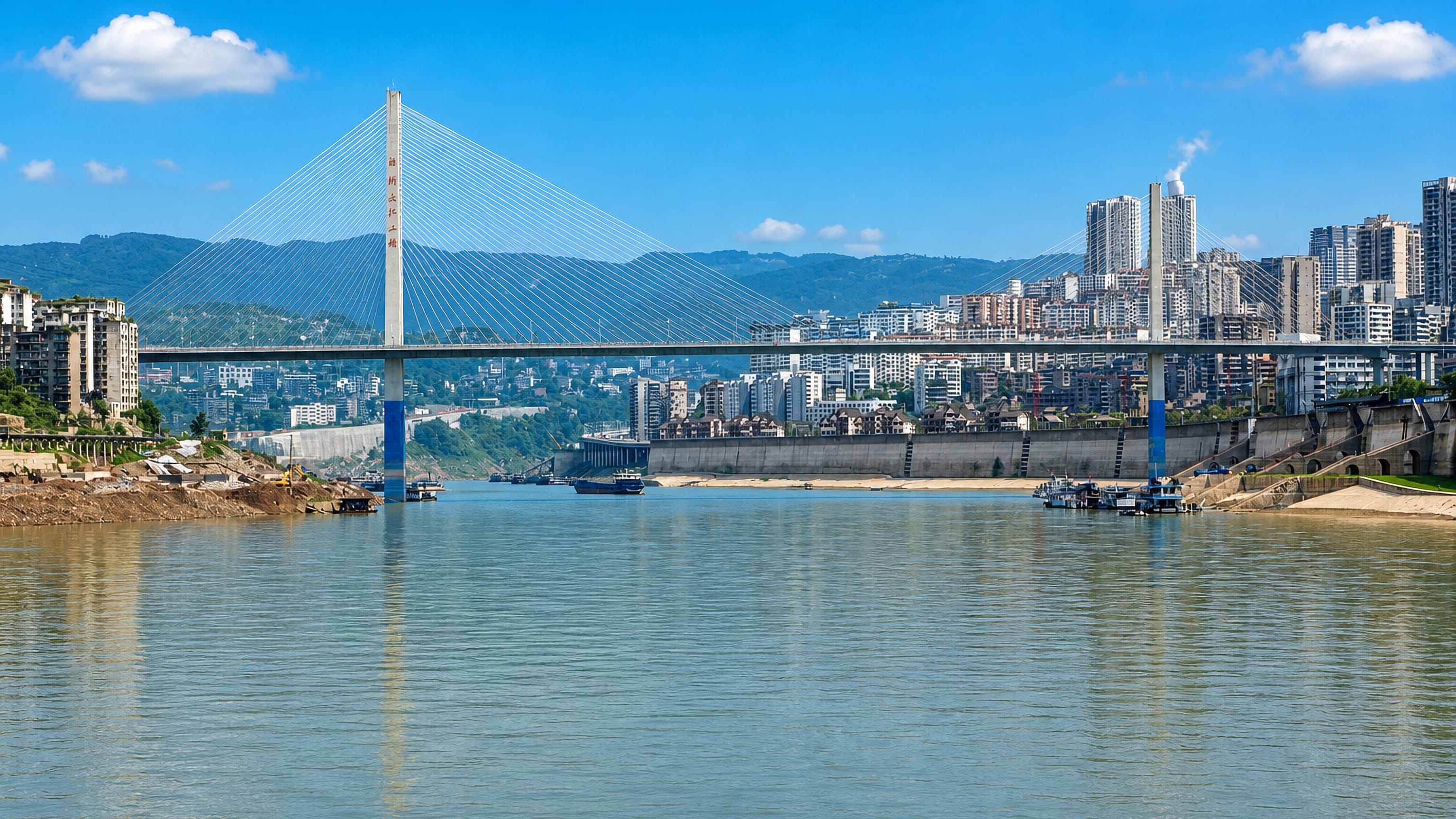 Cable-stayed bridge over the Yangtze River with riverside high-rises and mountains in Fuling, Chongqing