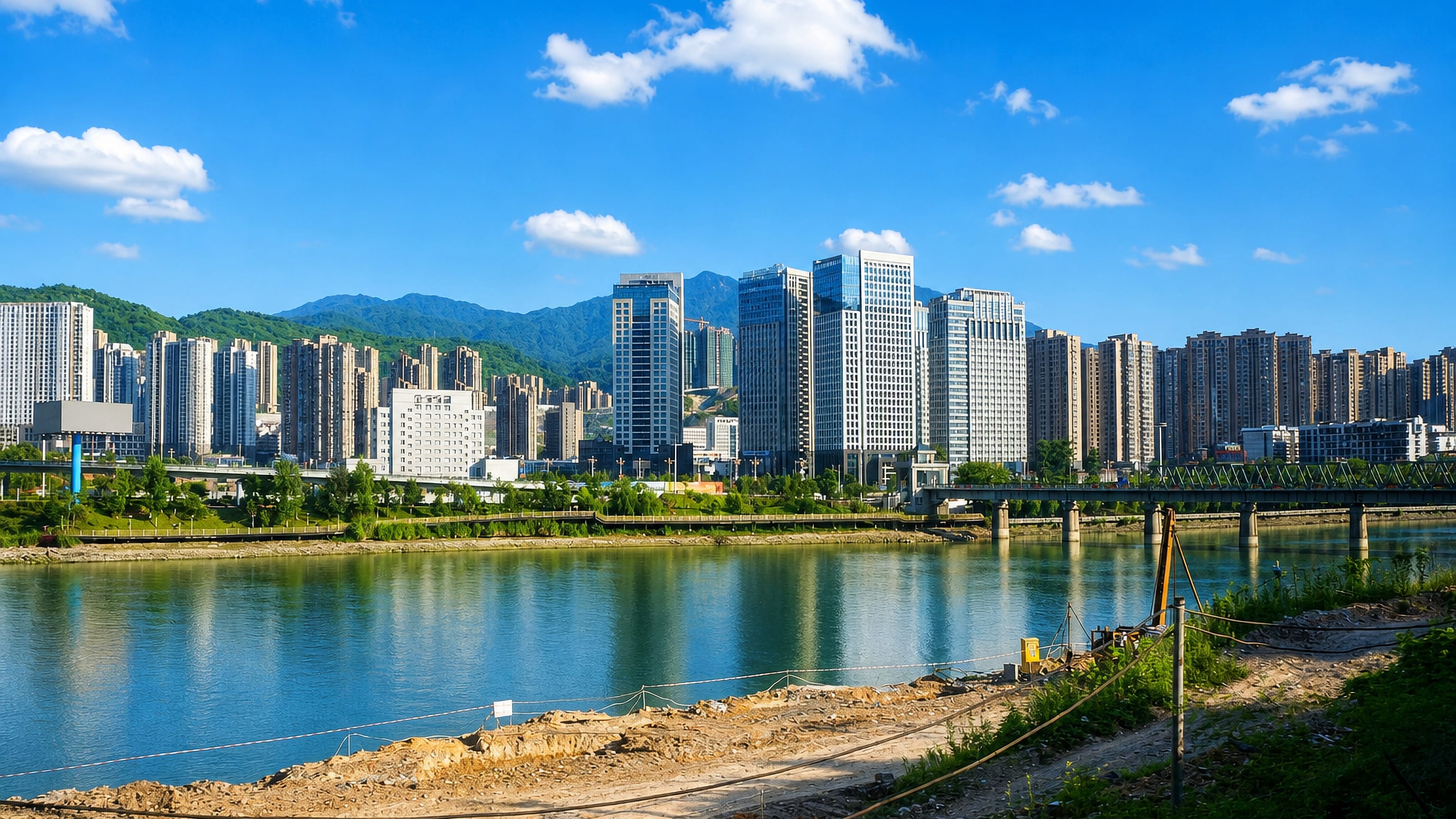 Riverside high-rises of Sanming, Fujian, lining the Sha River below forested mountains